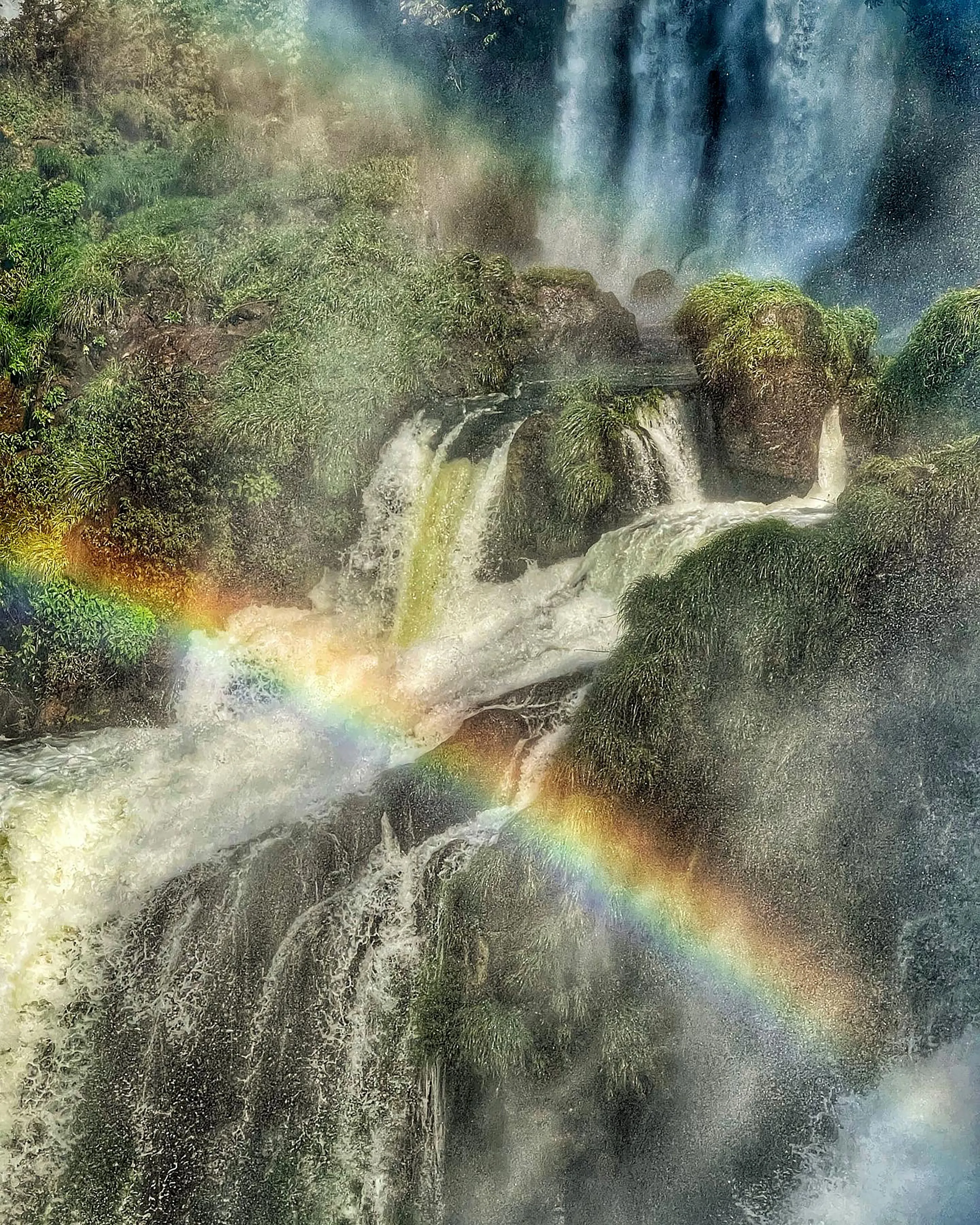 A rainbow above Iguazú's falling water and green forest