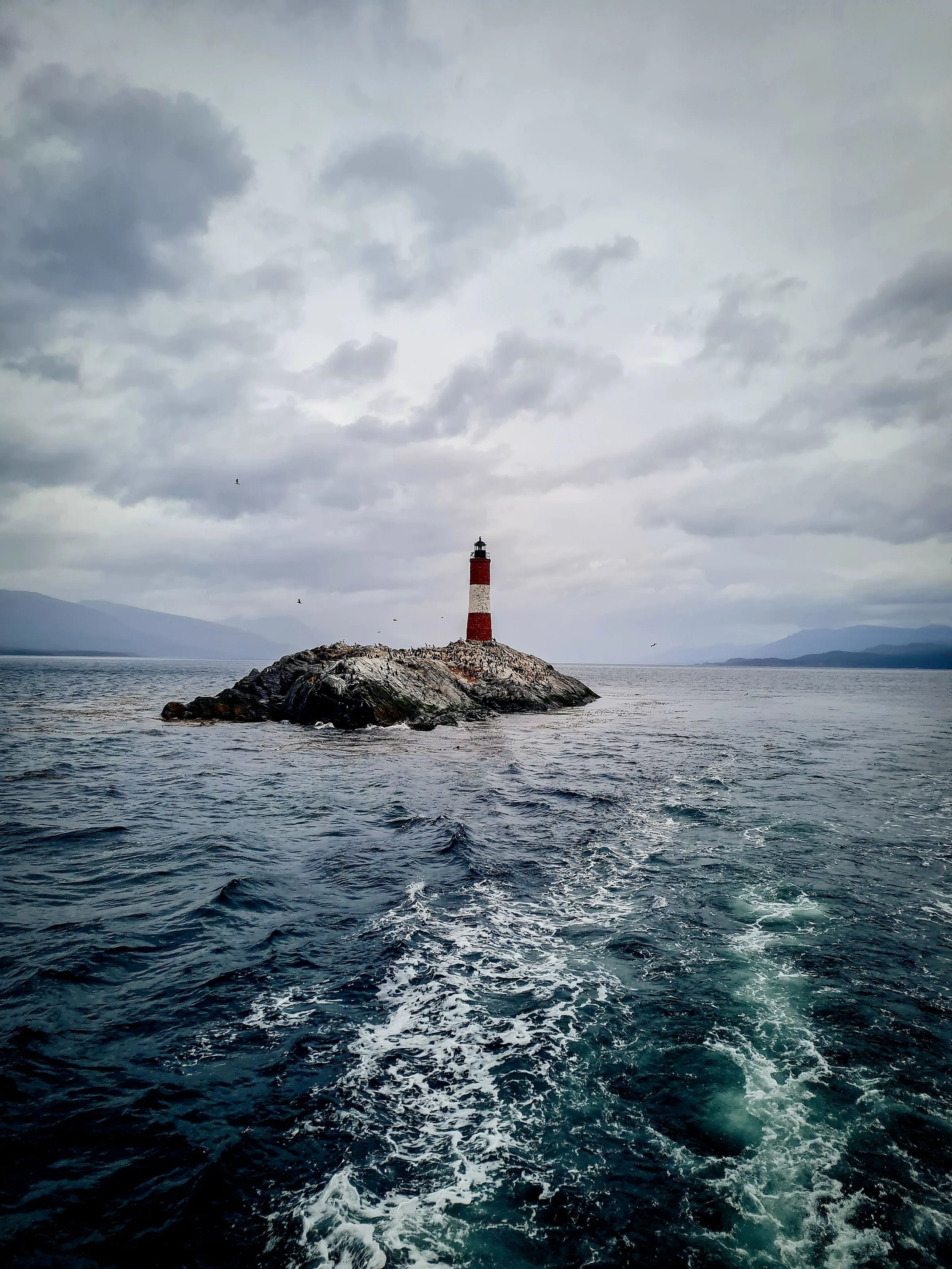 Les Éclaireurs lighthouse and rocky islands in the channel.