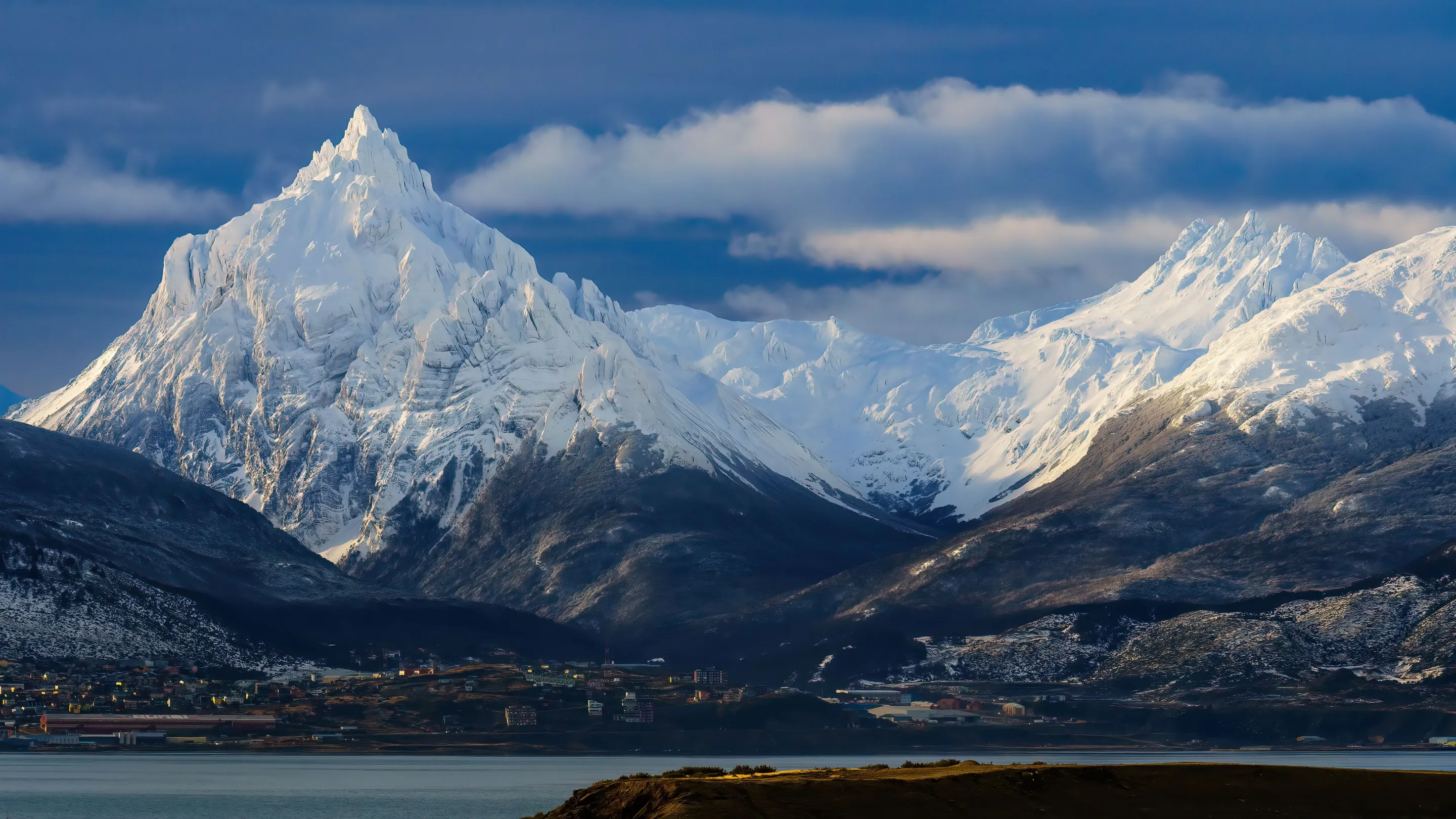 The buildings of Ushuaia below snow-covered mountains