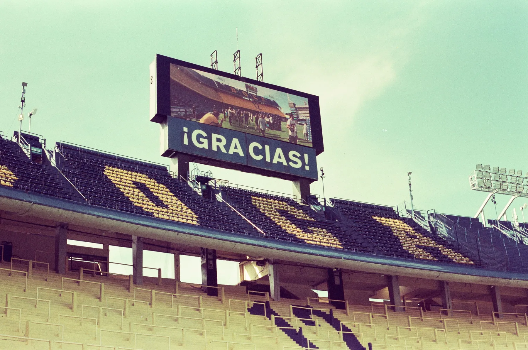 Blue and yellow stands of La Bombonera beneath its giant screen