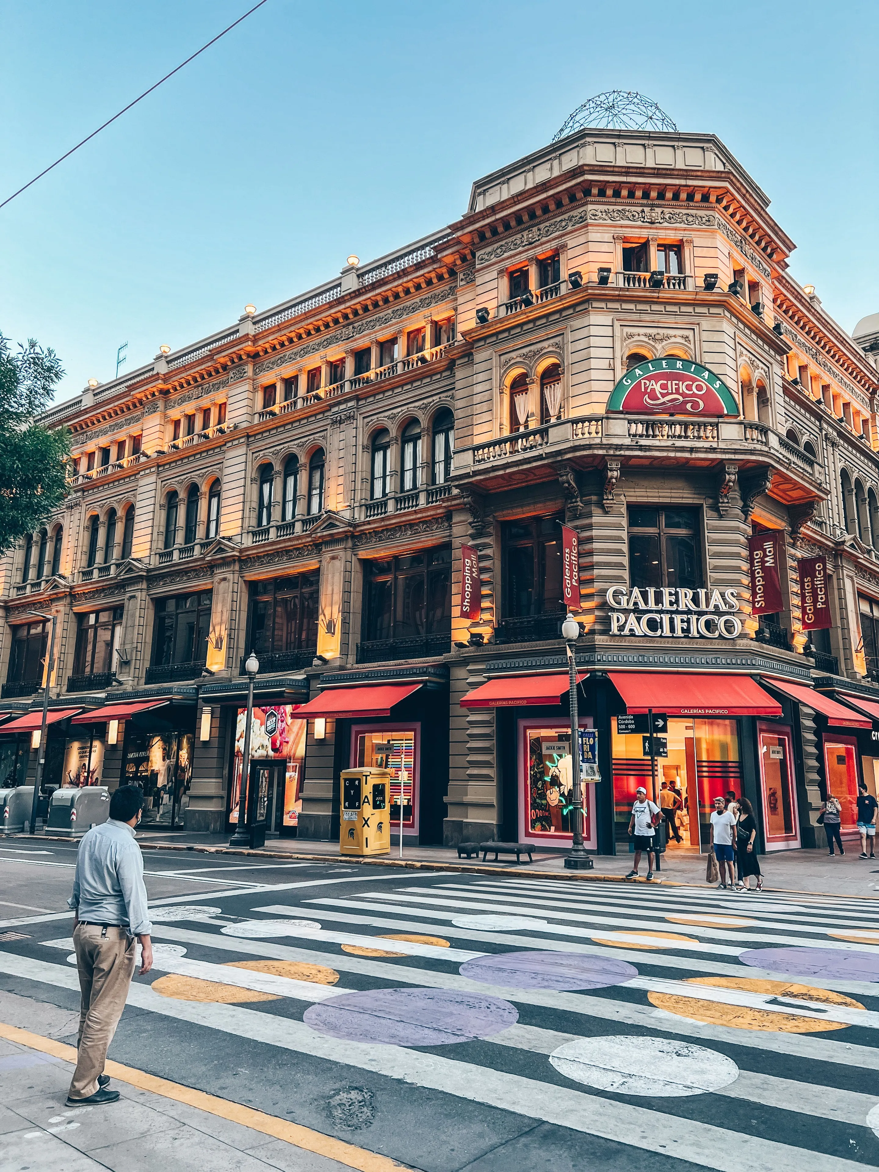 Galerías Pacífico's historic façade illuminated above the street