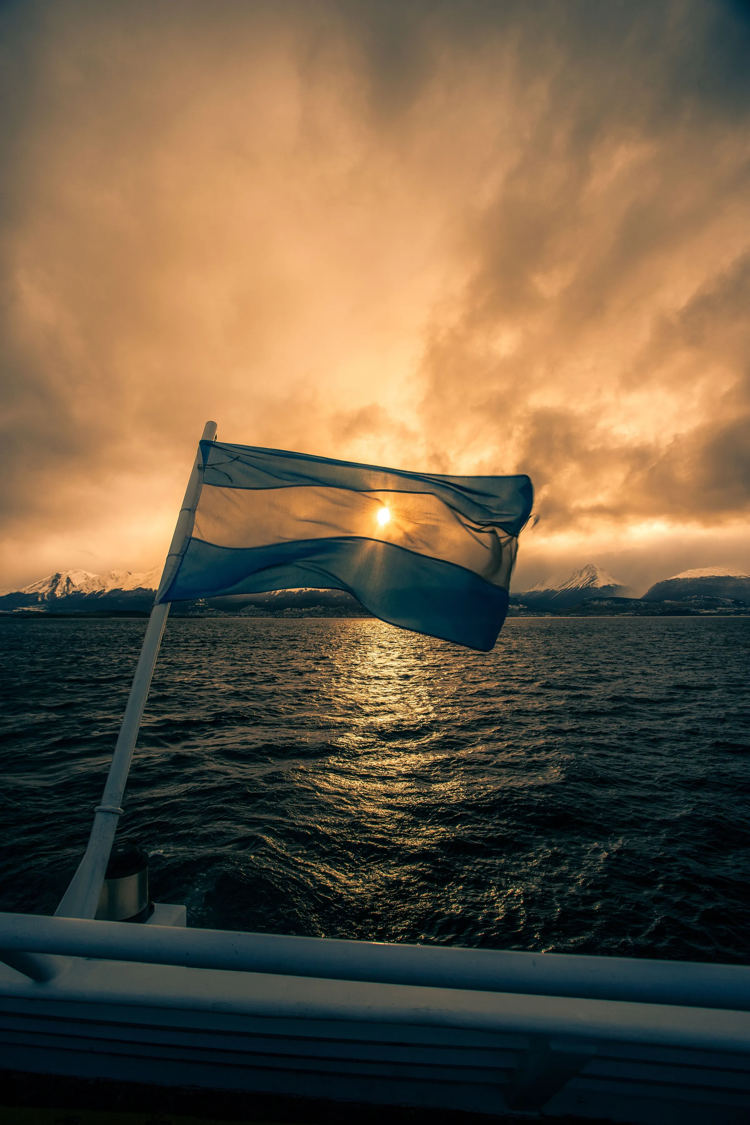 An Argentine flag above the water at sunset near Ushuaia.