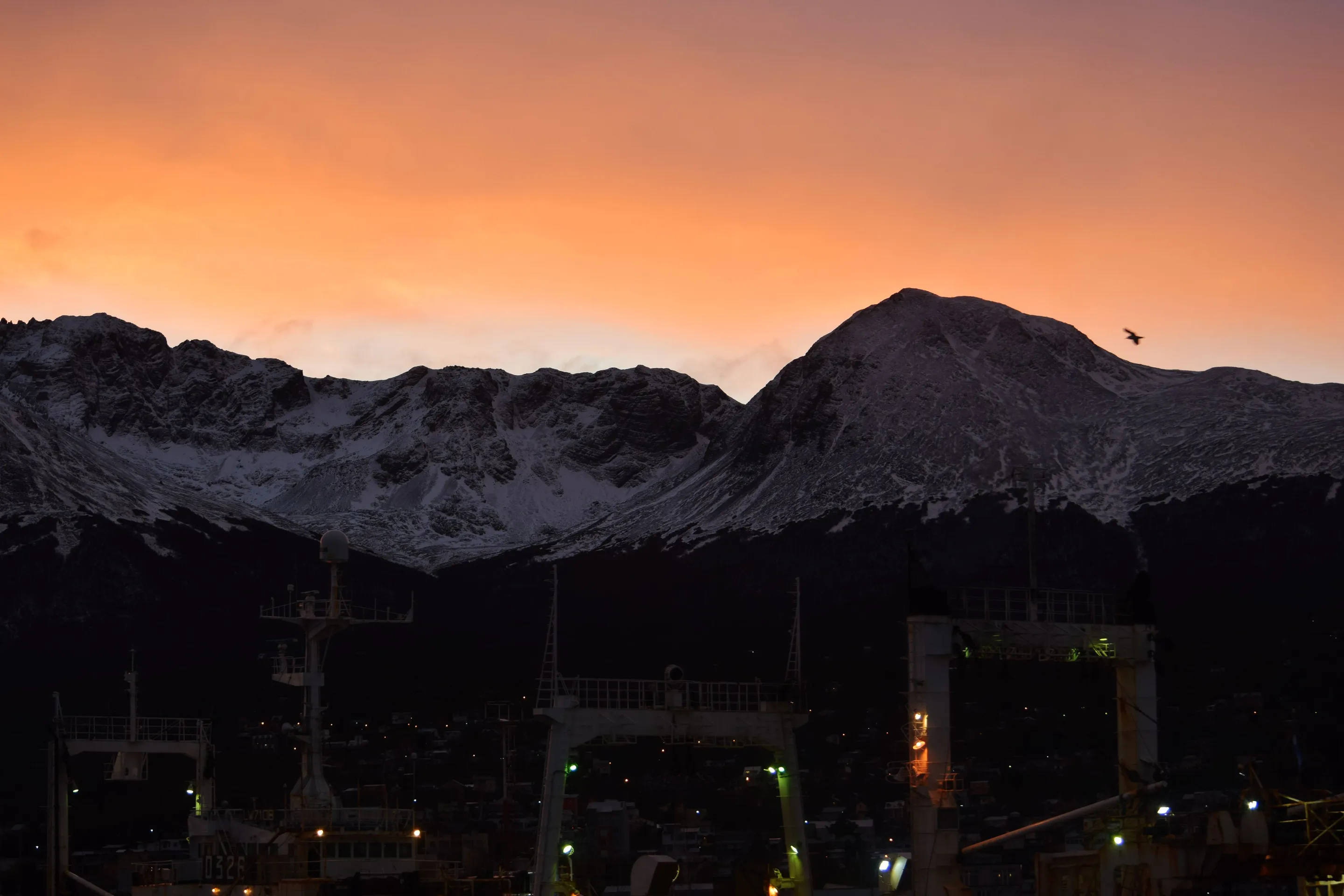 Sunset behind snowy mountains in Ushuaia.