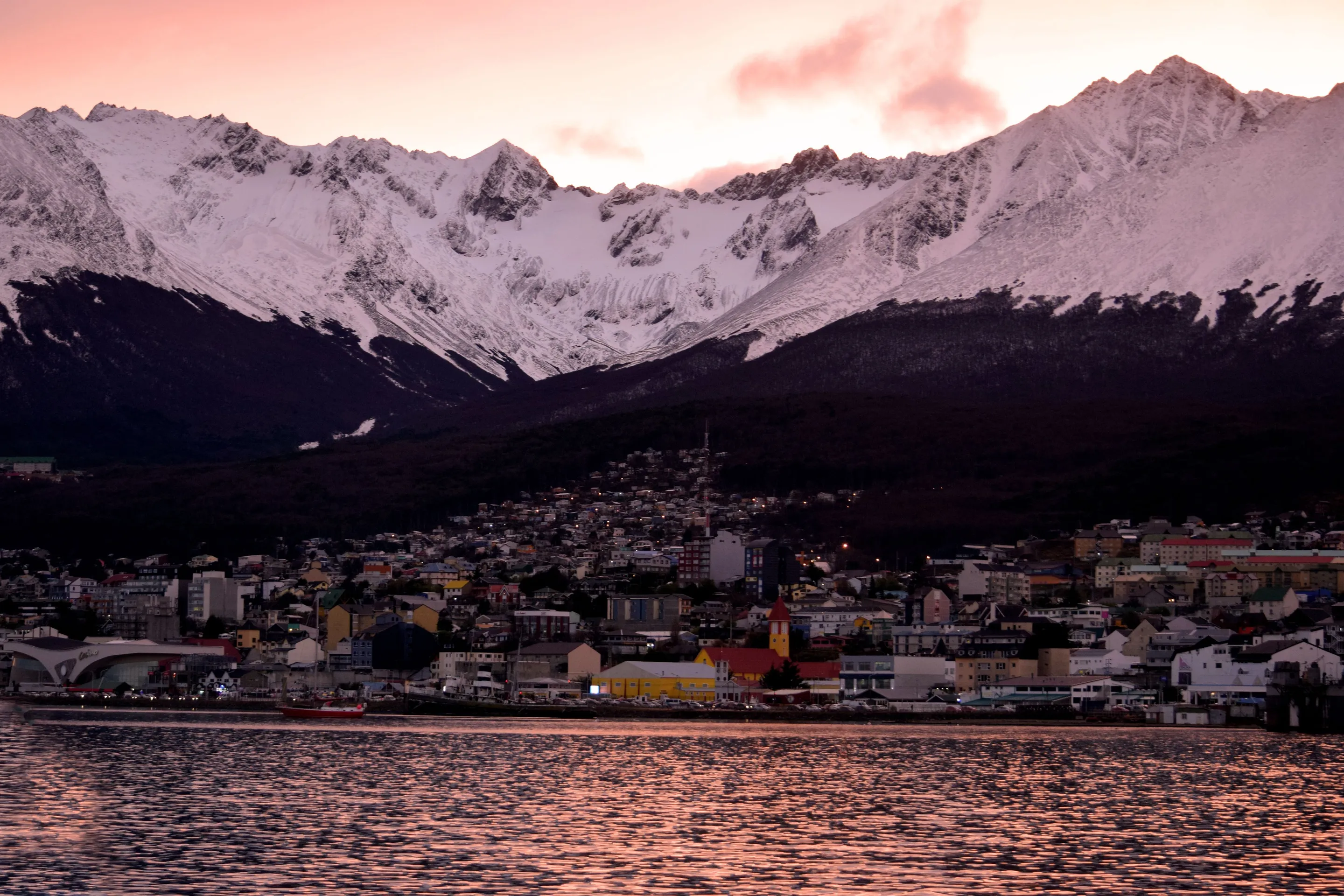 Ushuaia beneath snowy mountains in warm low light