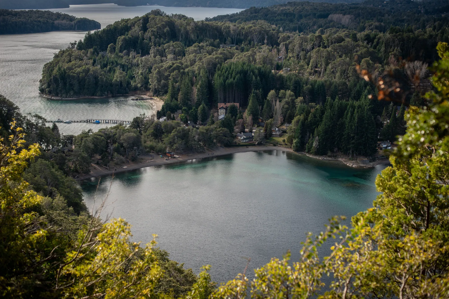 Aerial view of forested shores and clear Nahuel Huapi water near Villa La Angostura
