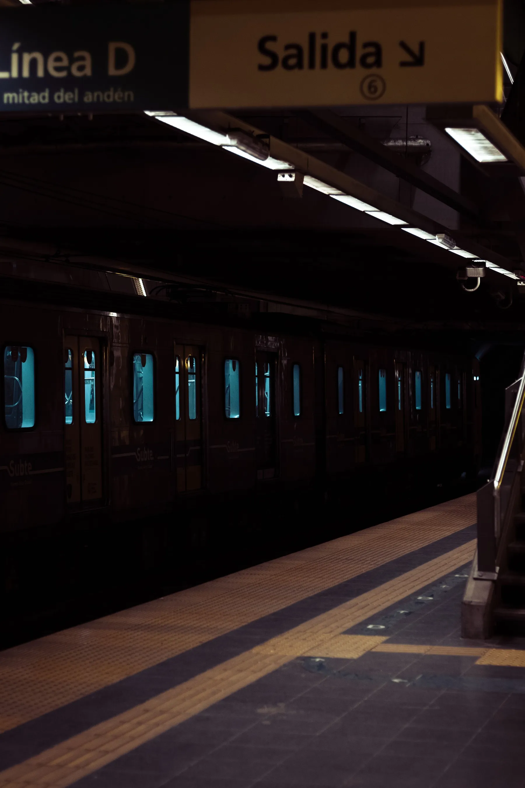 A train beside a dimly lit platform on Buenos Aires Subte Line D.