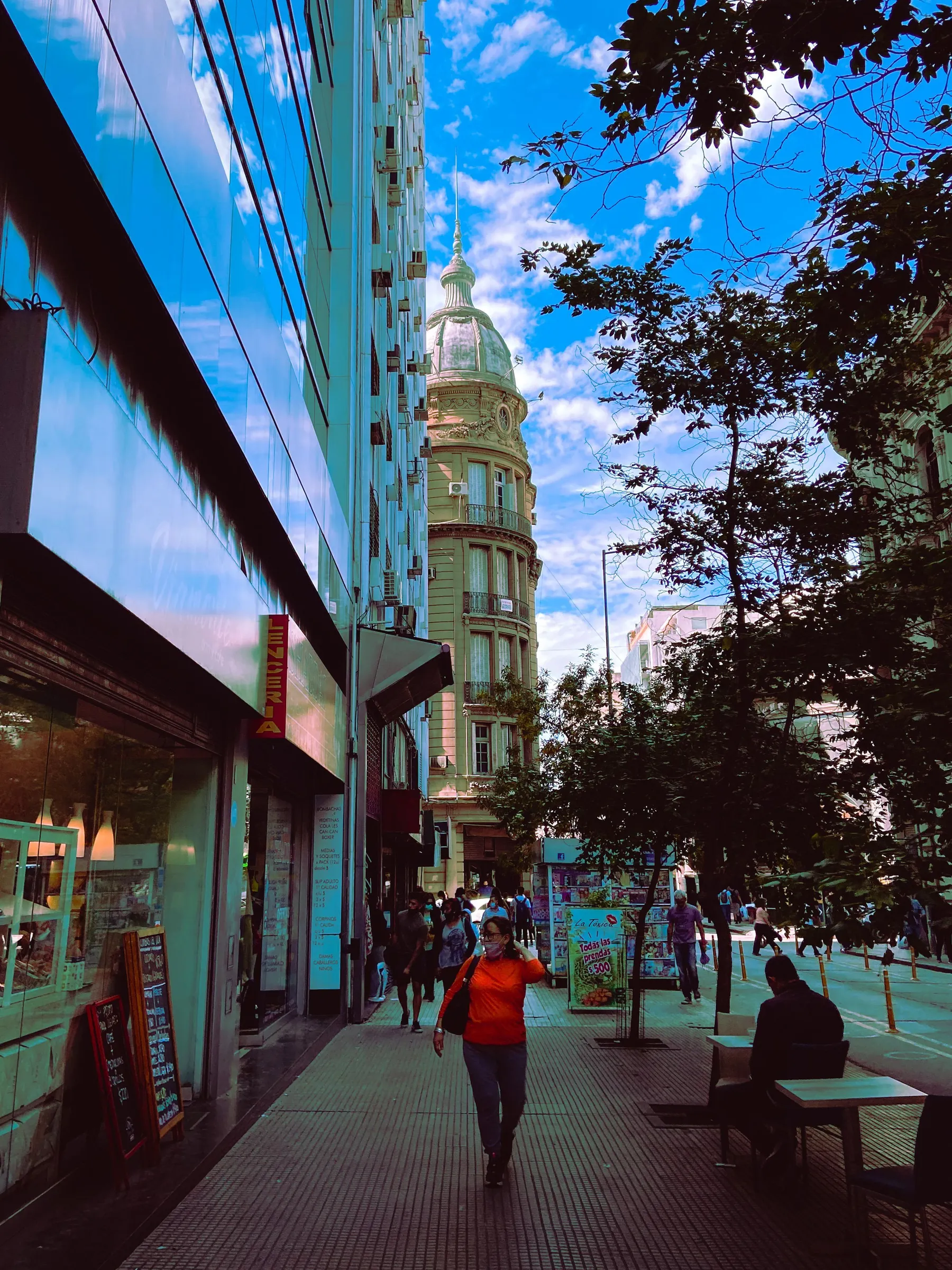 Historic architecture reflected in a modern building above a Córdoba street