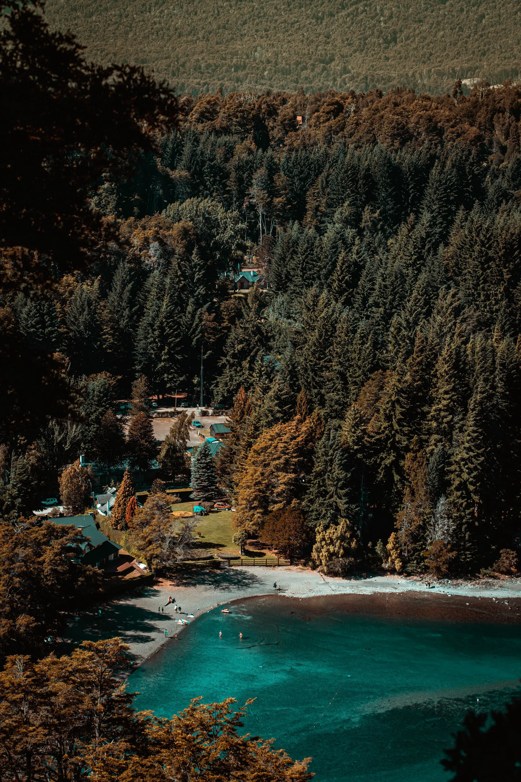 Turquoise water and wooded shoreline near Villa La Angostura