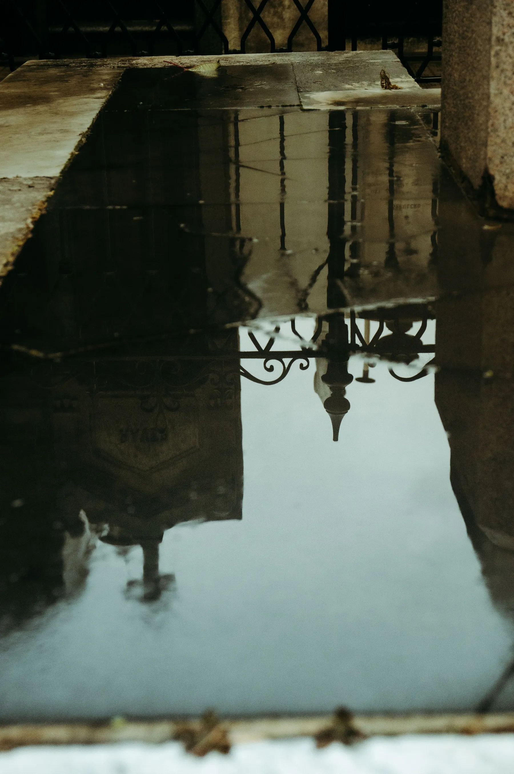 Buenos Aires architecture reflected in a street puddle.
