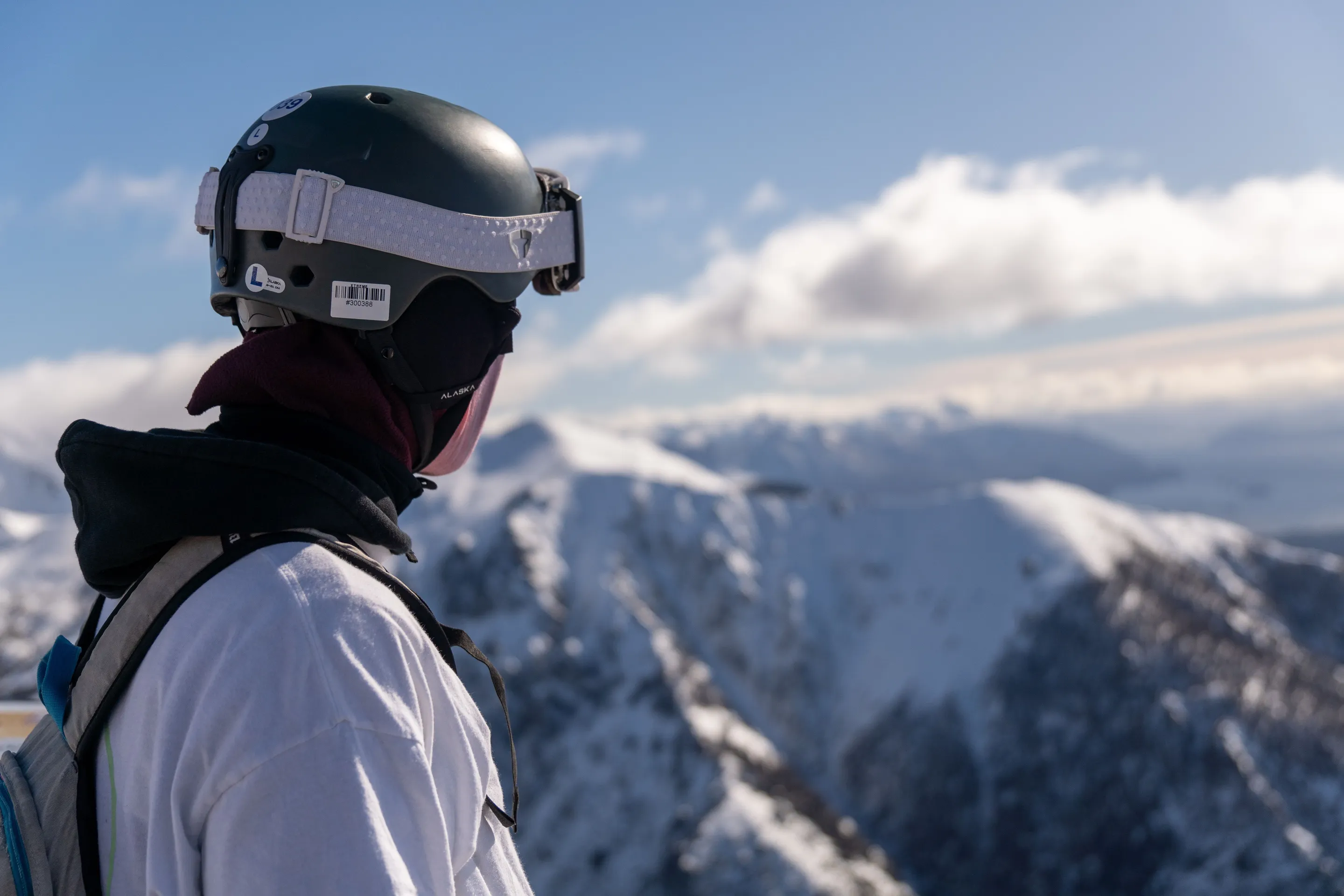 A helmeted mountaineer on snowy terrain near Bariloche.