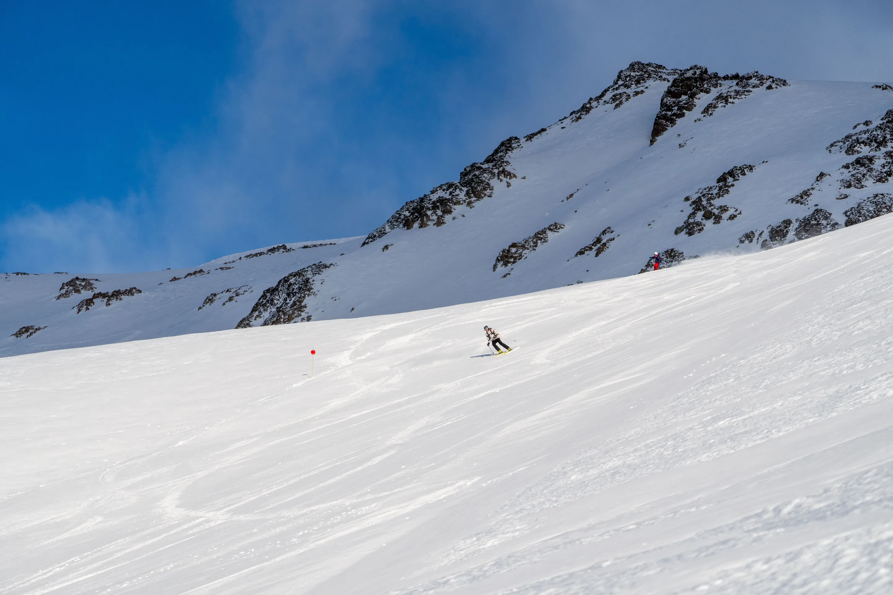 A skier descending a snowy slope in Bariloche.