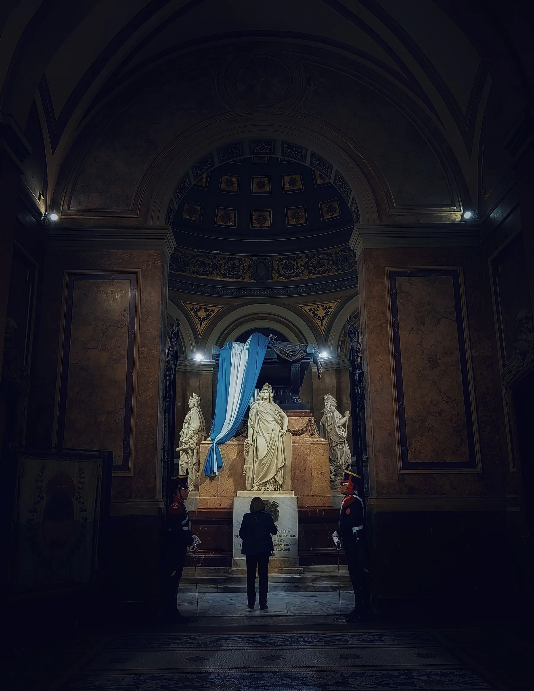 Guards and visitors beneath the ornate architecture inside the Metropolitan Cathedral