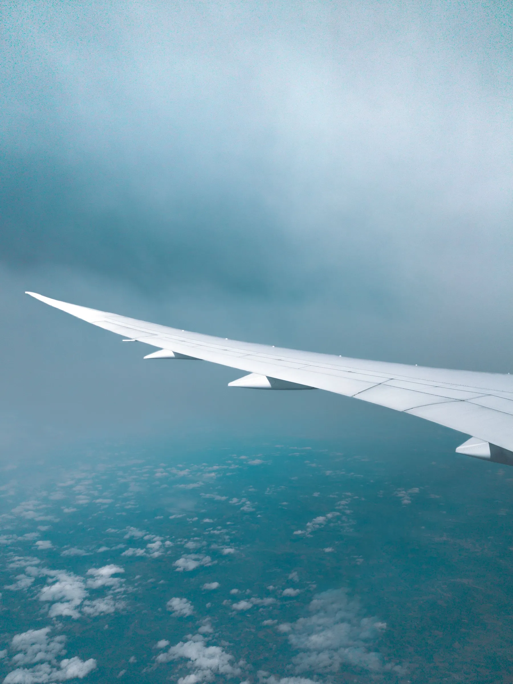 An aircraft wing above clouds over Argentina.