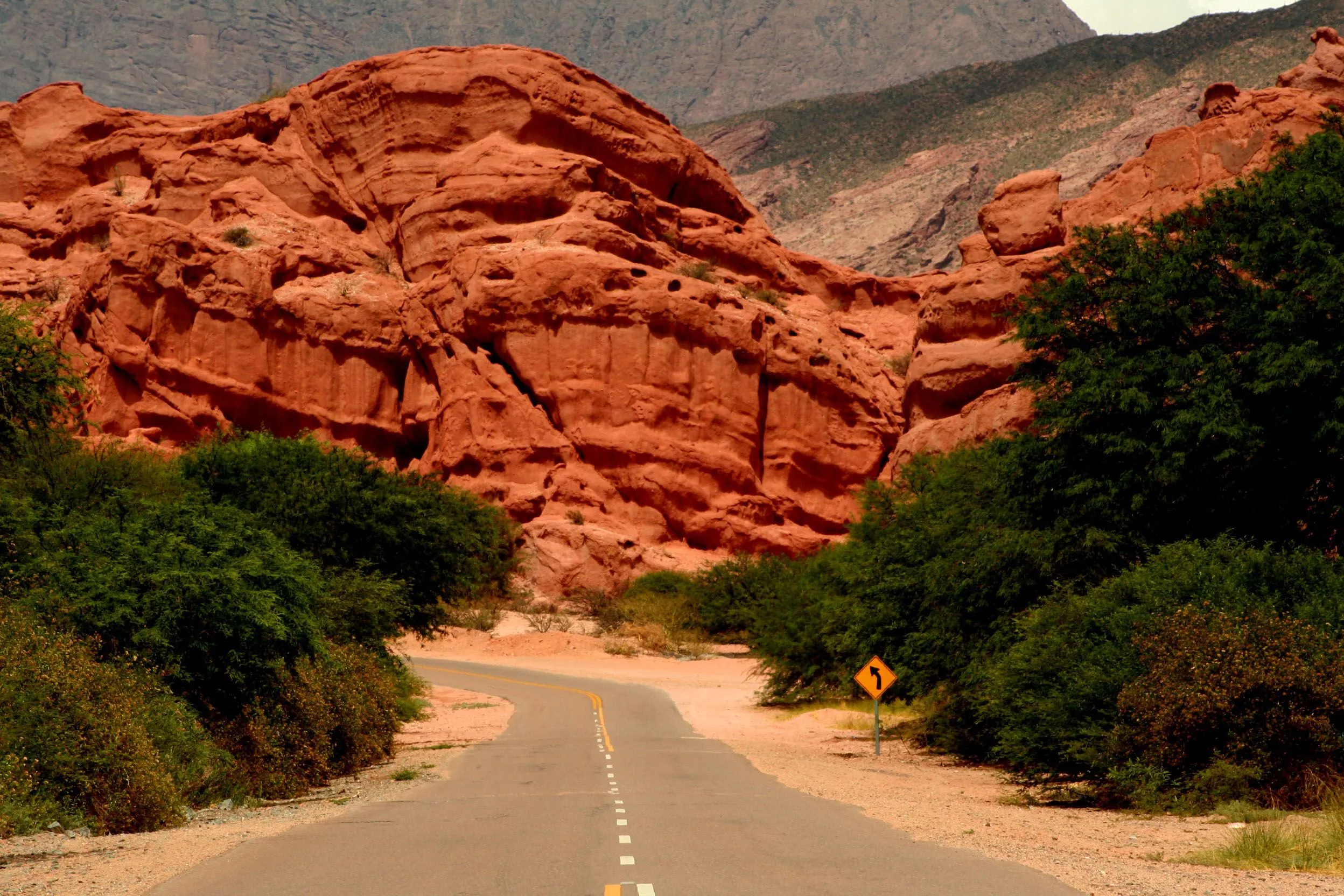 A winding road among the red rock walls of Quebrada de las Conchas