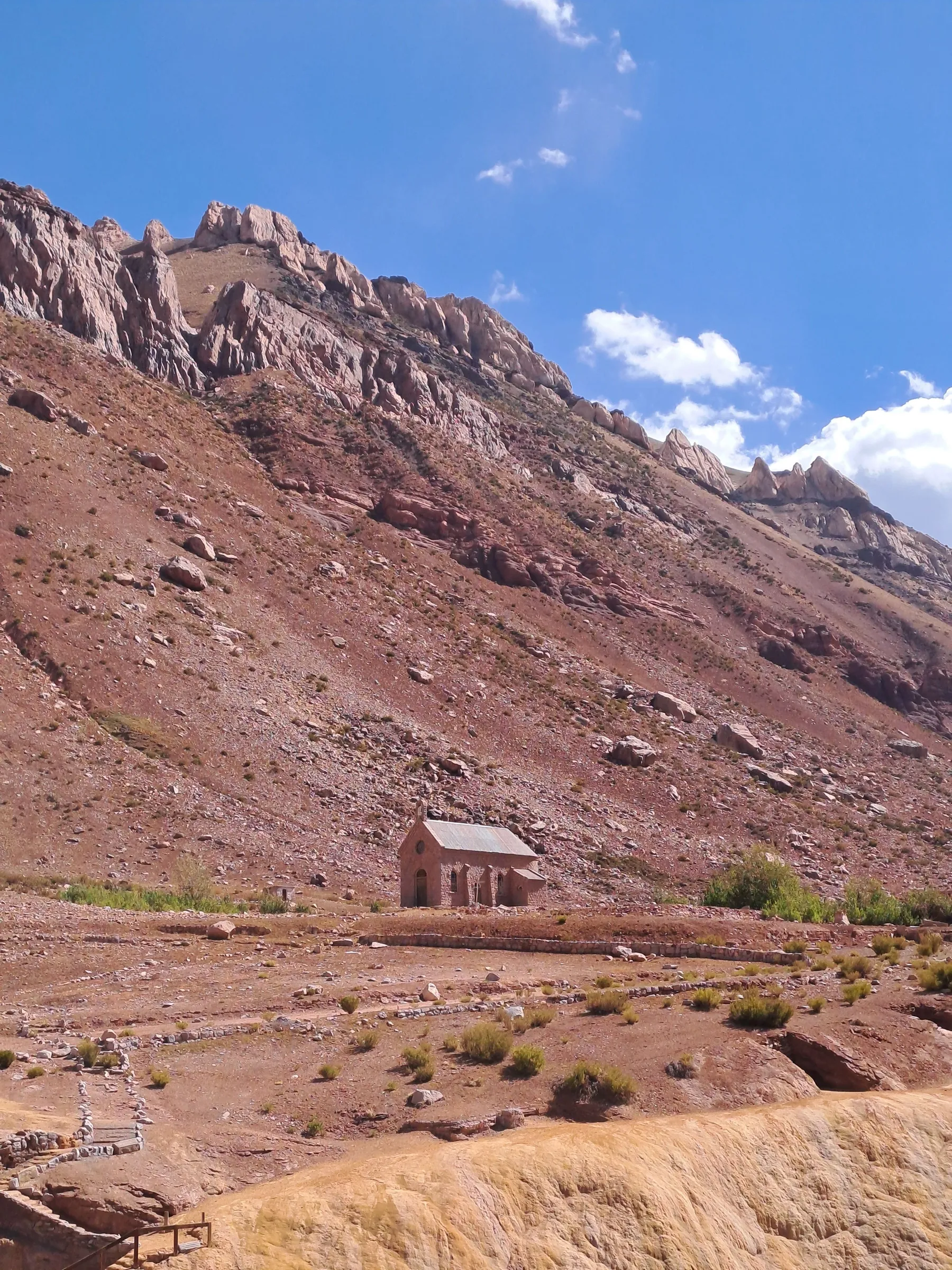 A small hut below the rocky mountains of Aconcagua Provincial Park