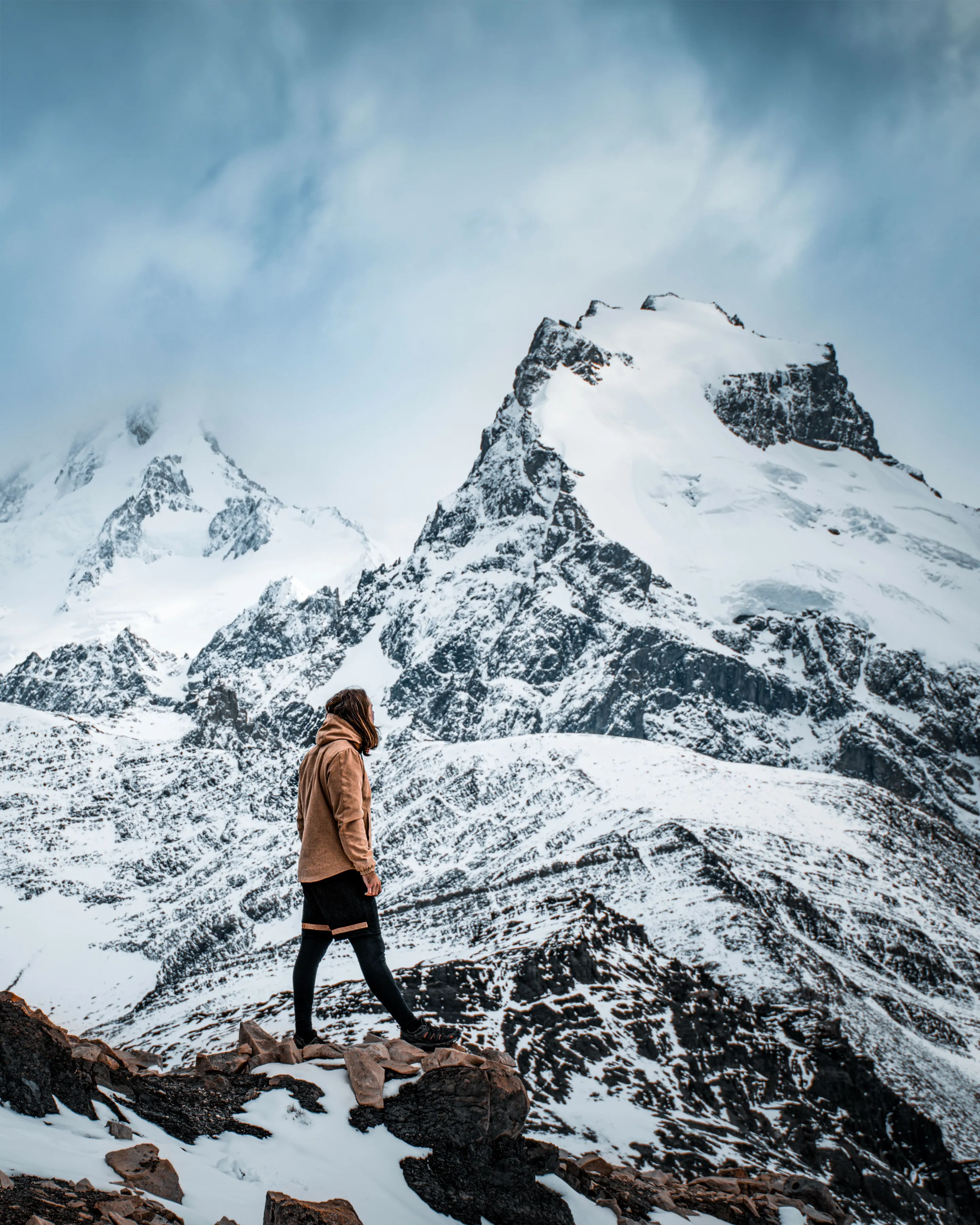 A hiker among snowy mountain scenery near El Chaltén.