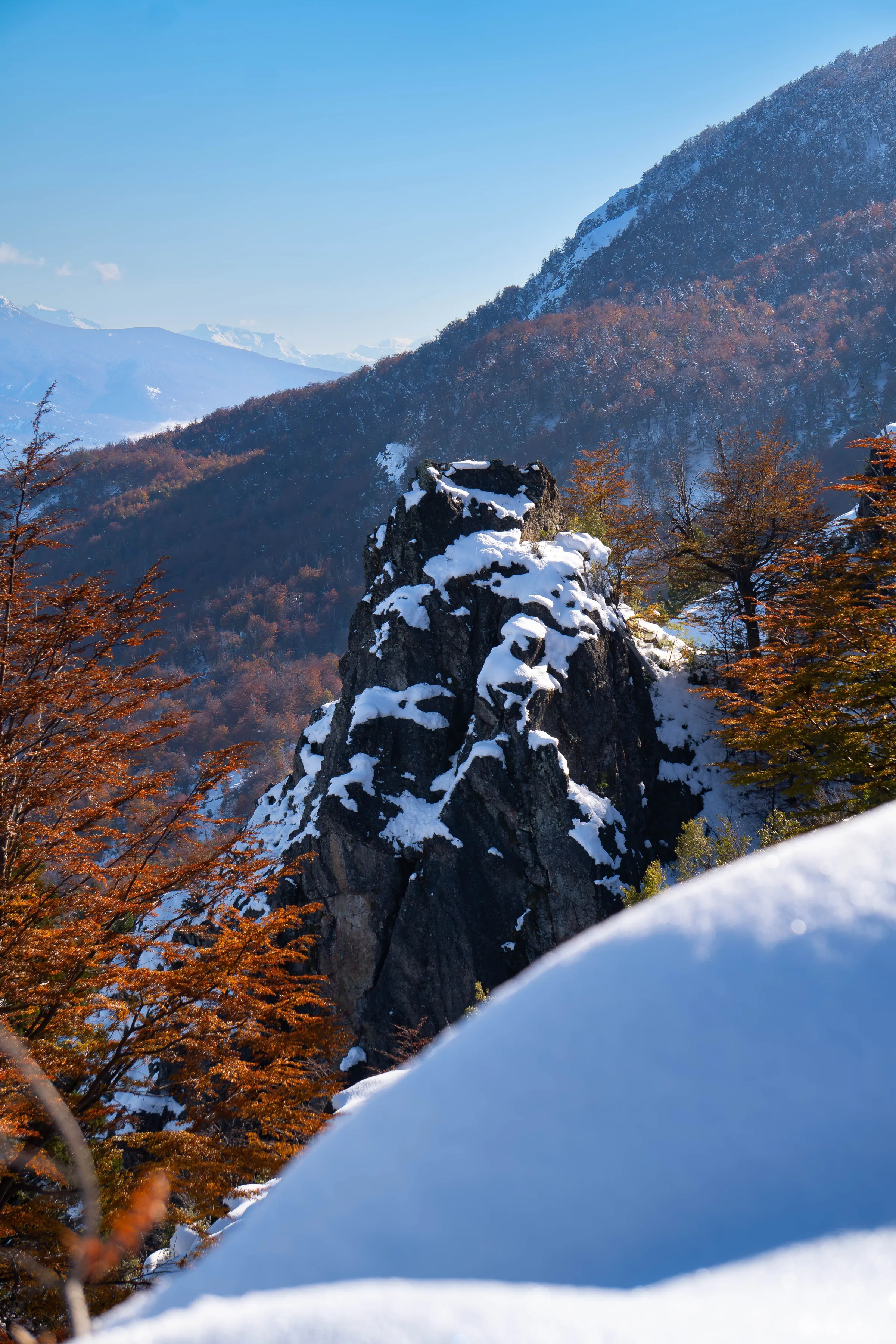 Dark rock cliffs and autumn foliage in the mountains above El Bolsón