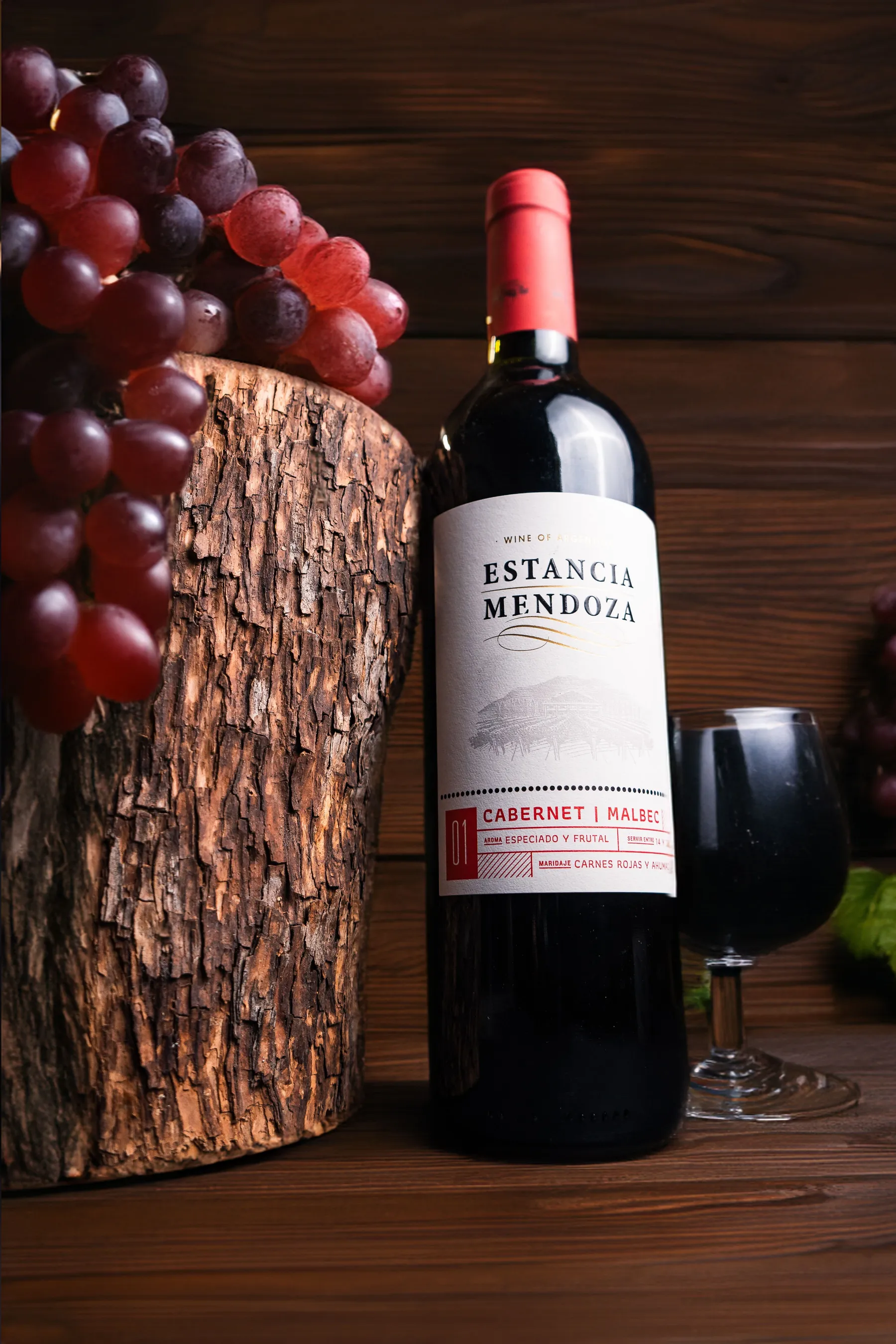 A Mendoza red-wine bottle arranged with grapes.