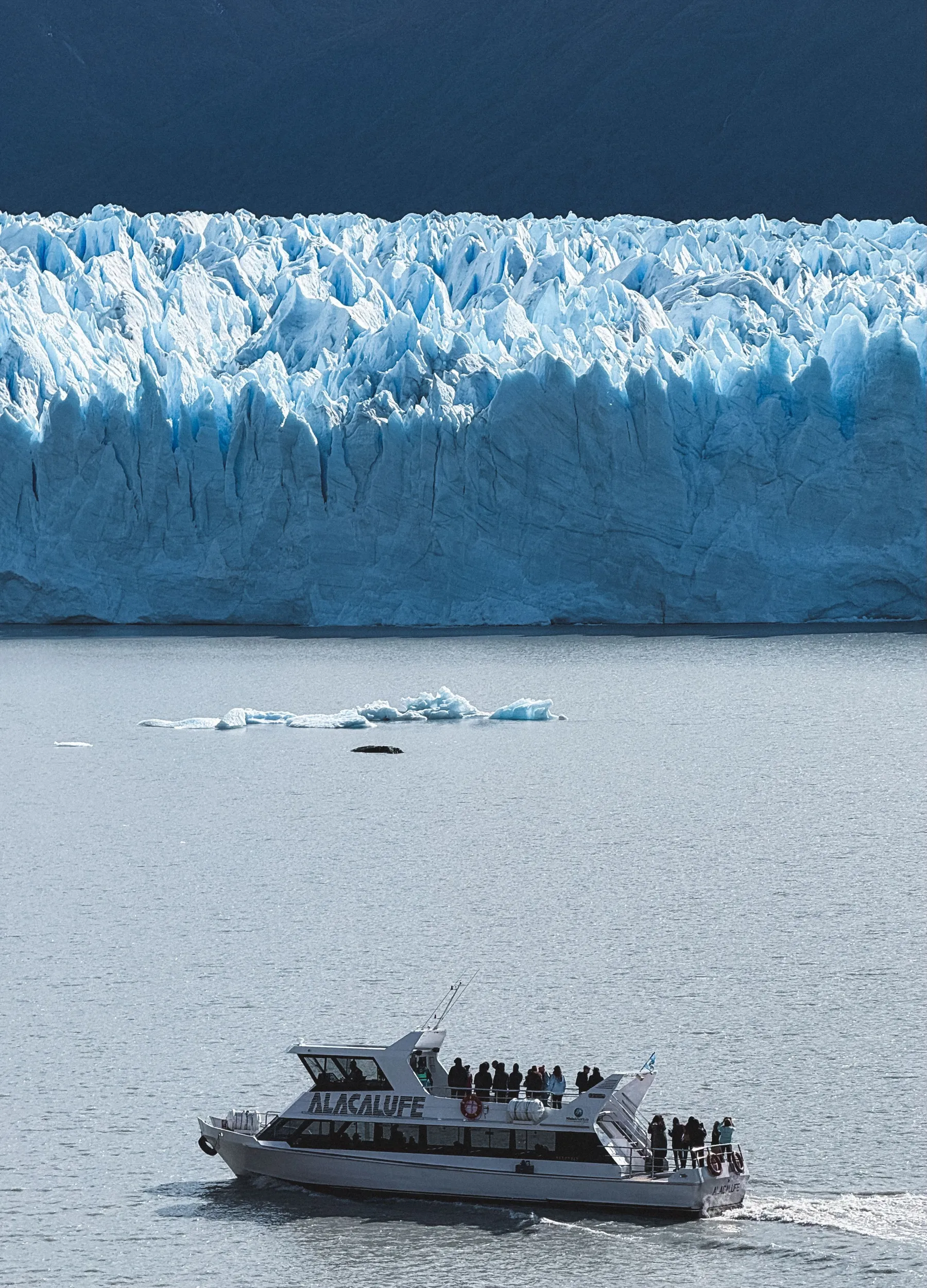 A passenger boat beneath the Perito Moreno ice front