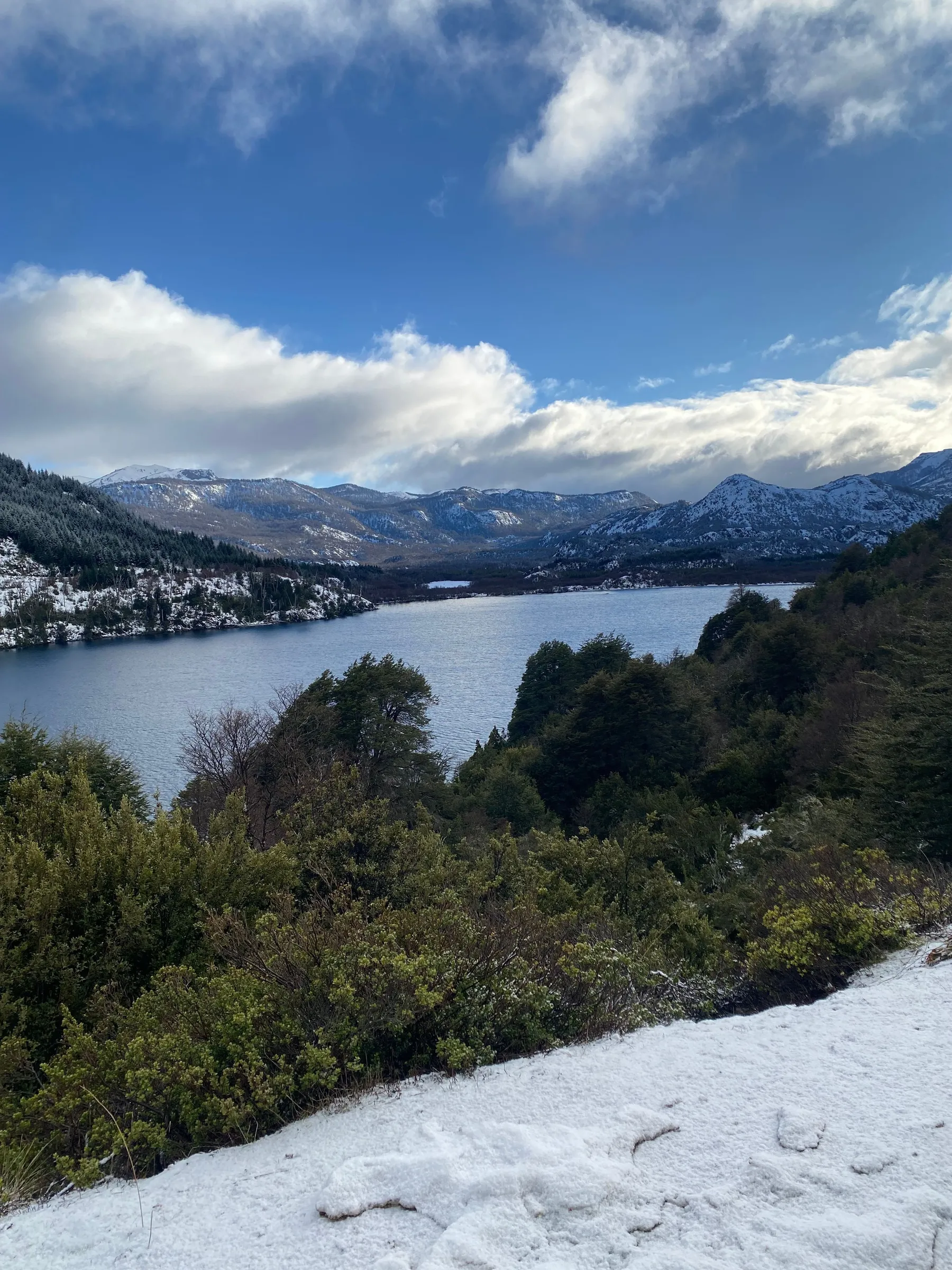 Snow-covered mountains and blue water in the northern lakes corridor