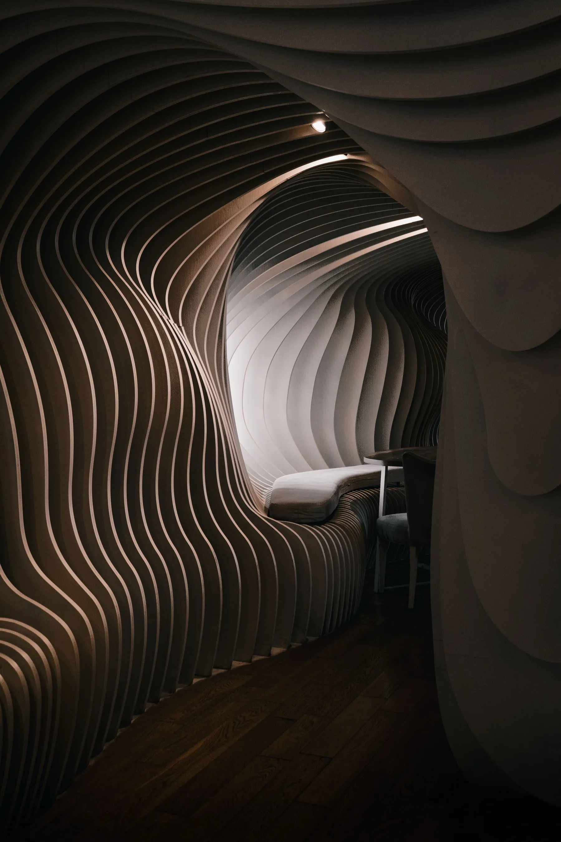 Sculptural curves and soft light in a Buenos Aires café interior