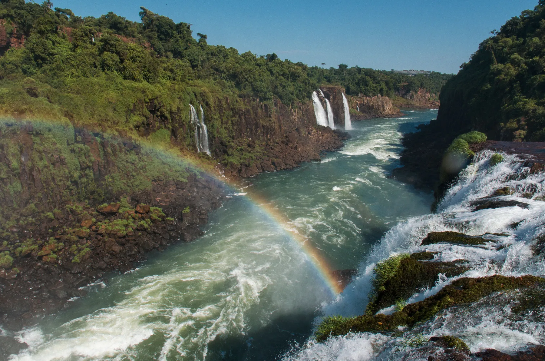 Rainbow and mist above rushing water in the Iguazú gorge
