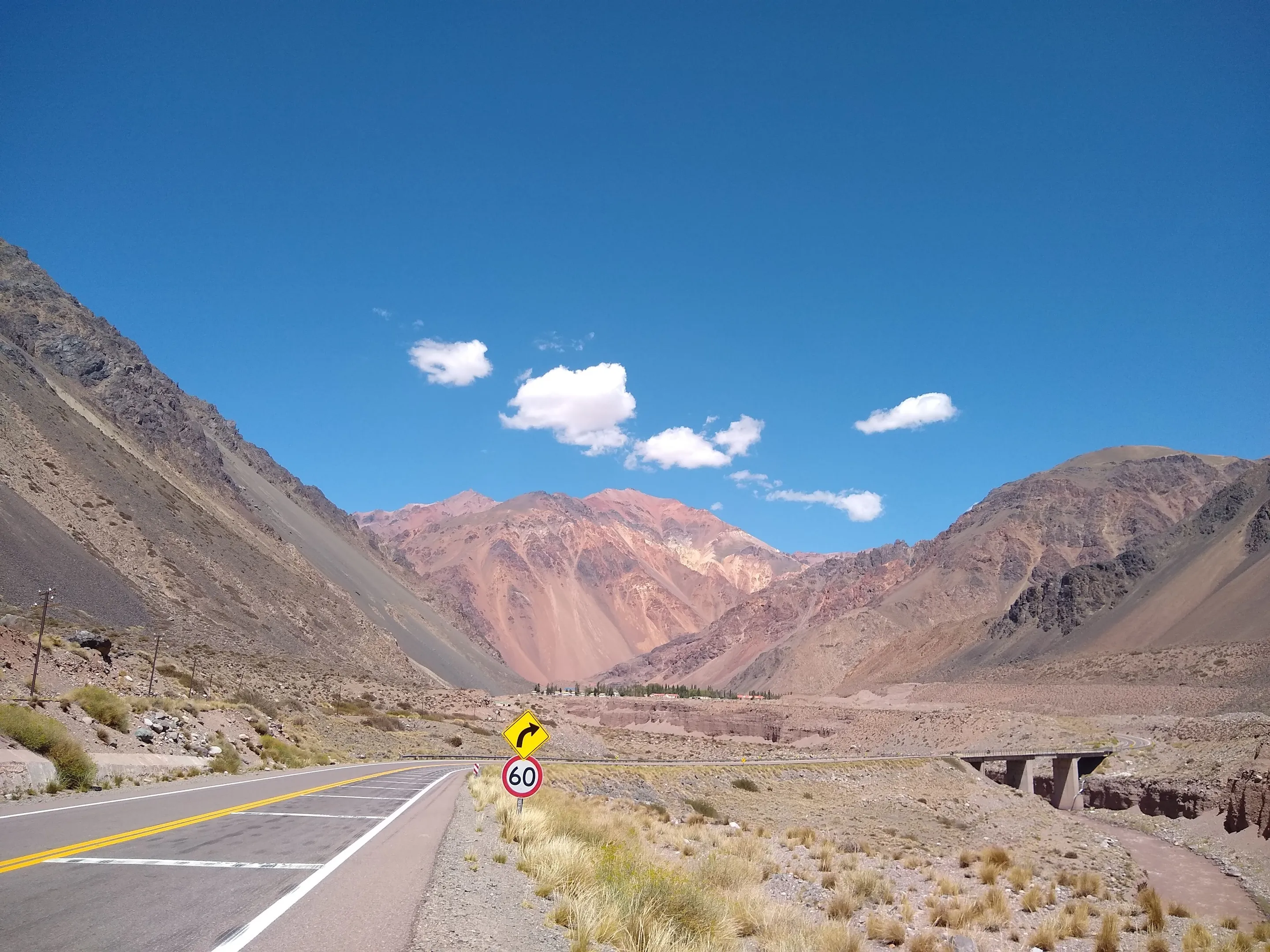A paved road winding through the dry Andes in Mendoza.