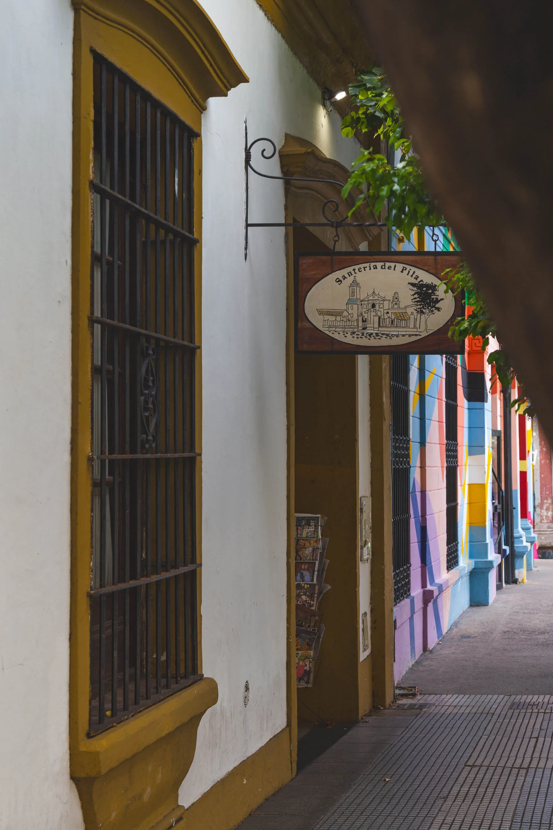 Painted street façades and a café canopy in Recoleta