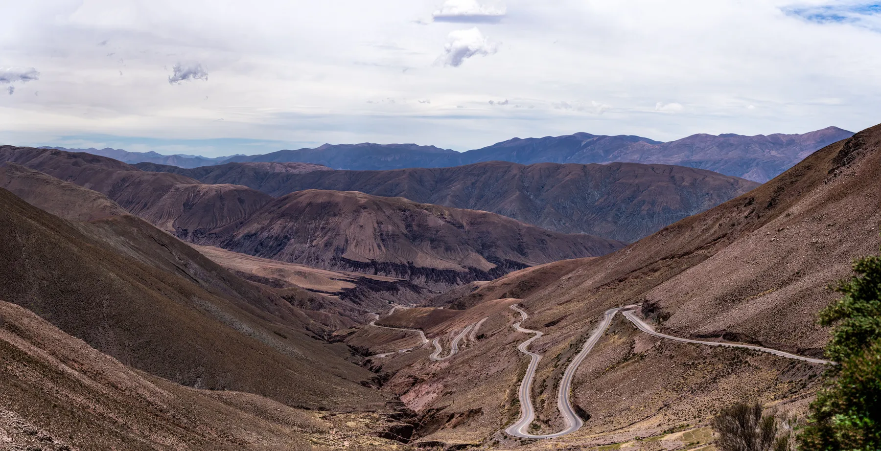 A winding road through the coloured mountain landscape of Salta