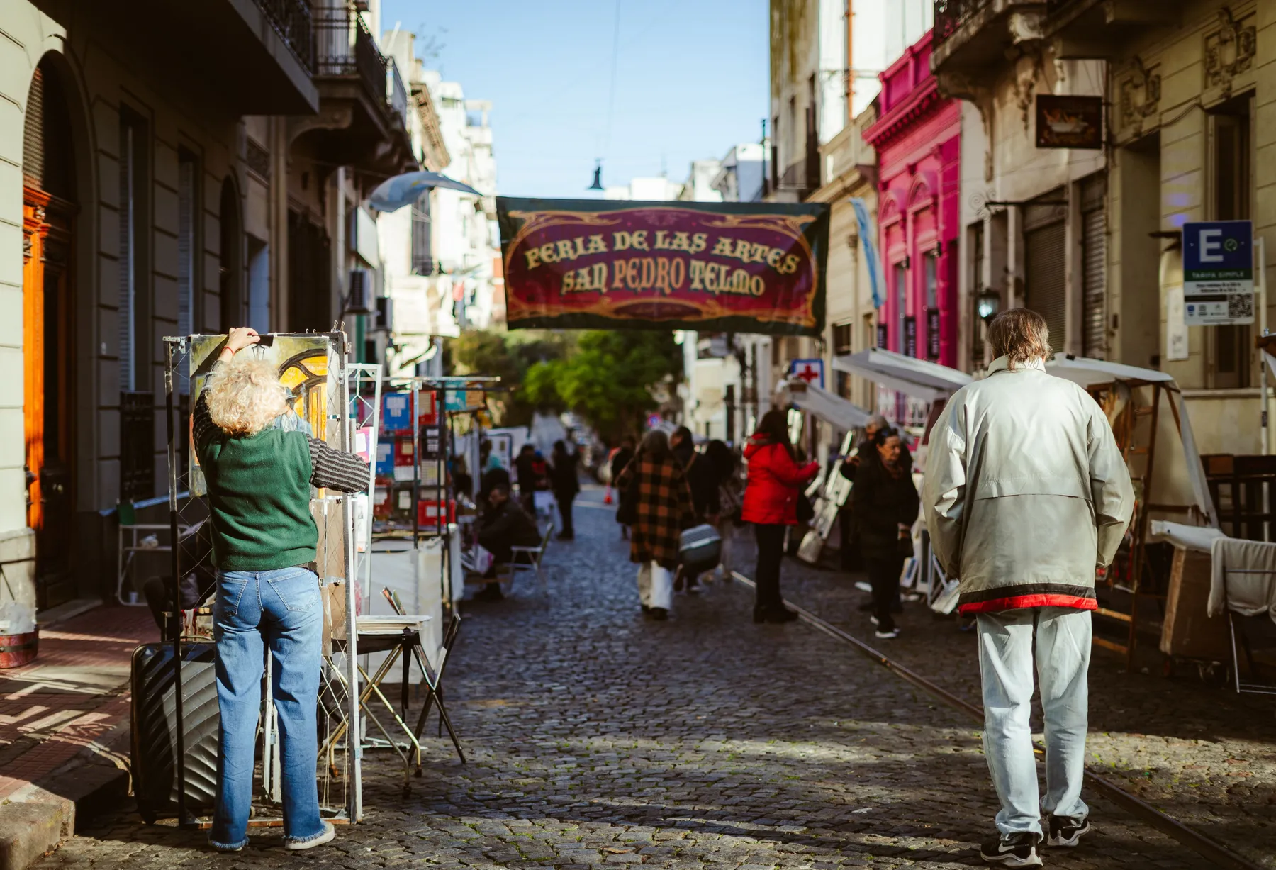 Colourful stalls and visitors at the outdoor San Telmo fair