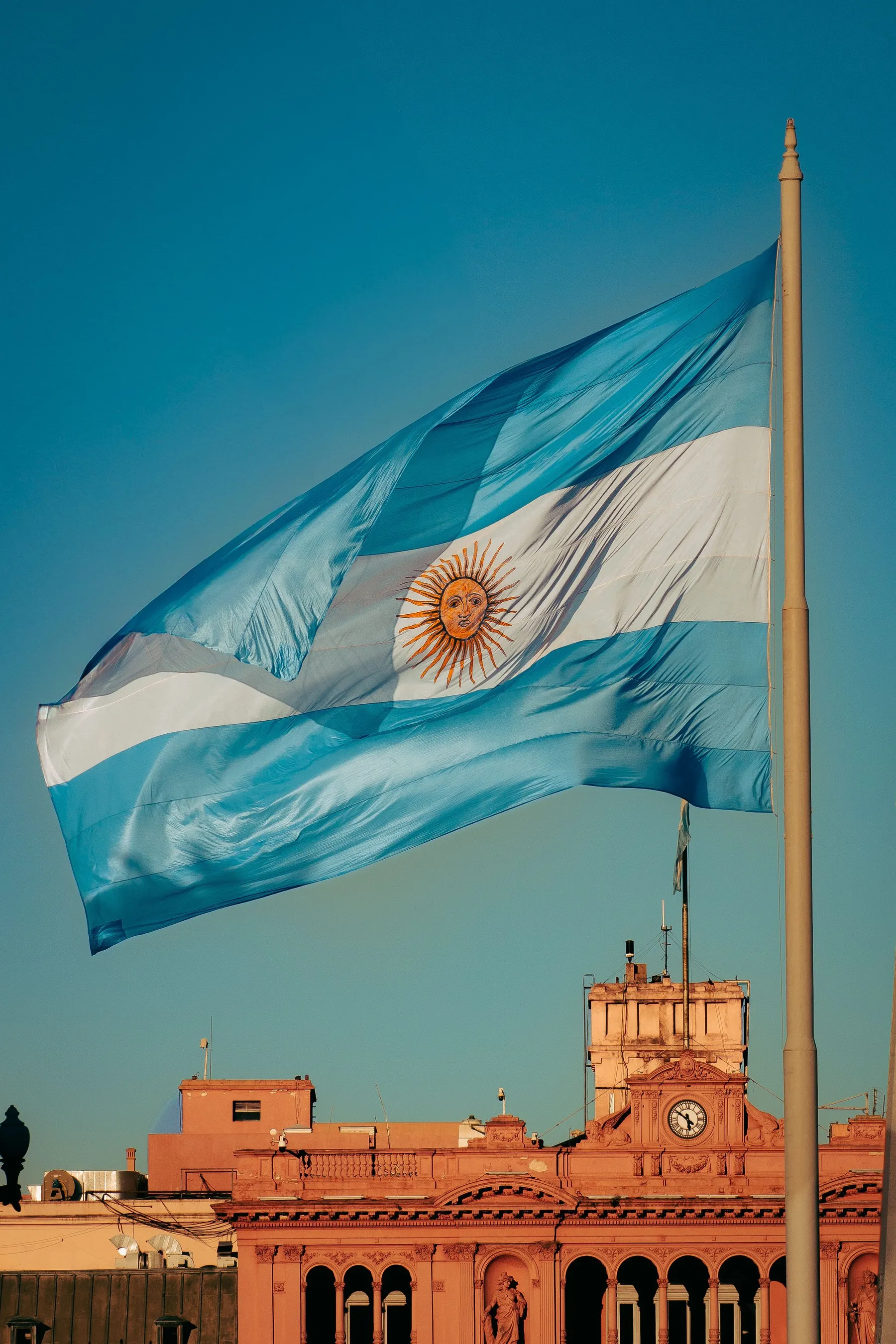 The Argentine flag above the architectural detail of Casa Rosada.