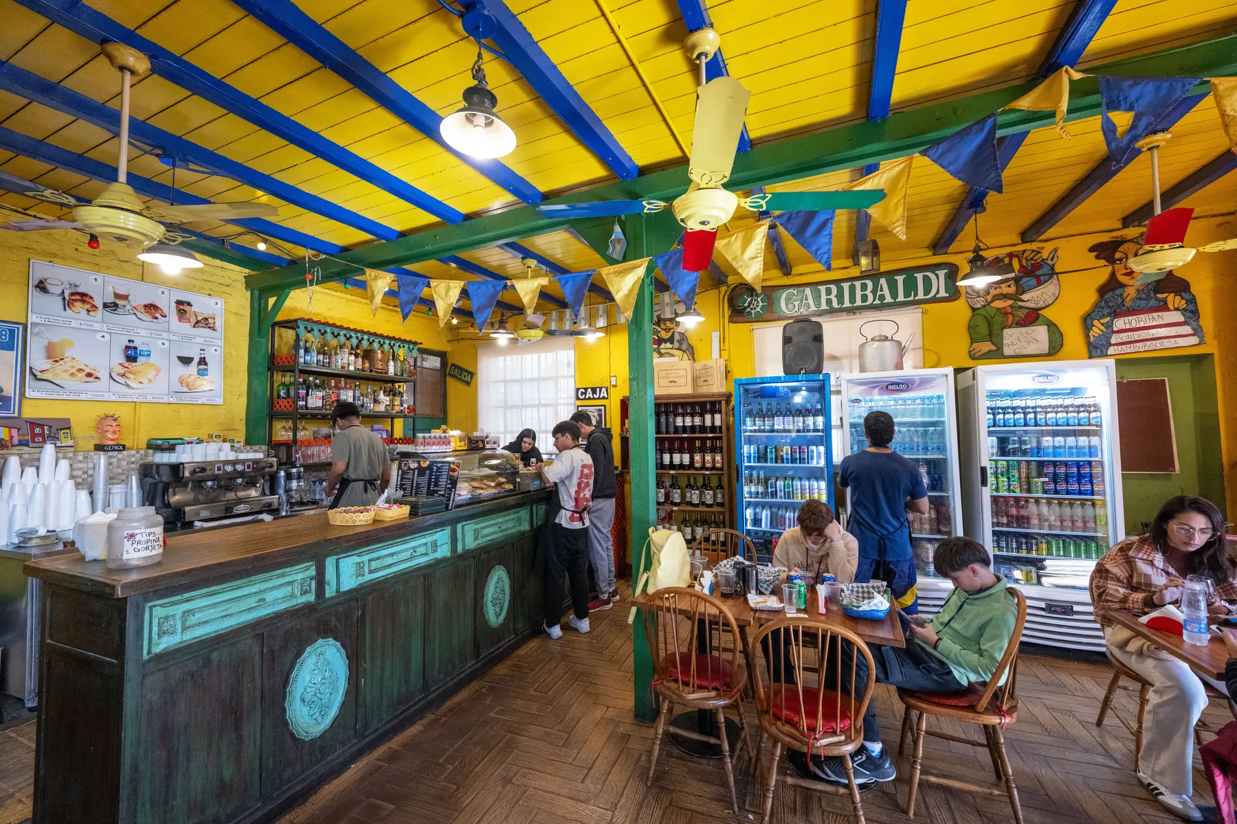 People at the counter of a colourful Buenos Aires café