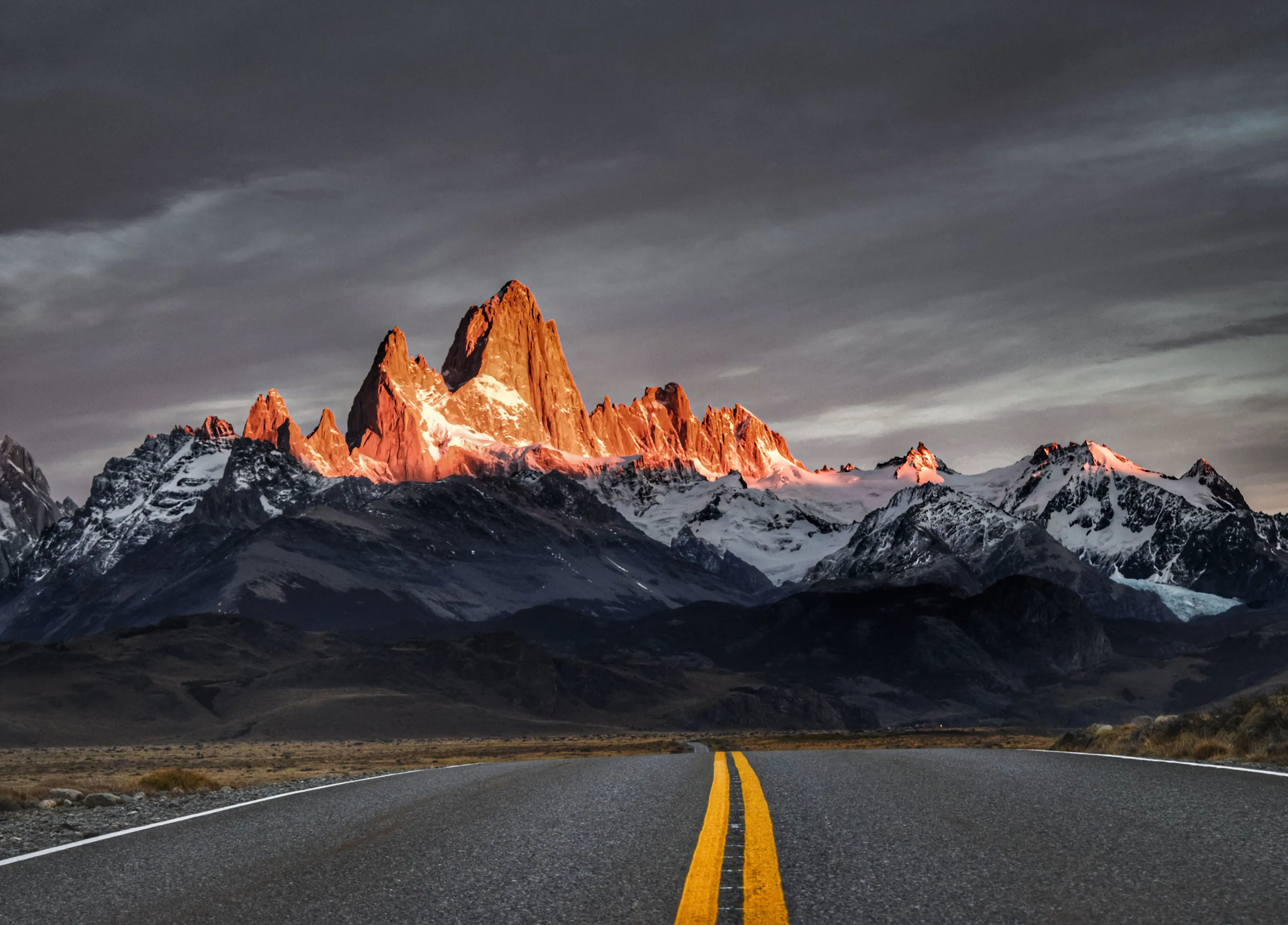Sunrise light on the Fitz Roy peaks beyond the road to El Chaltén.