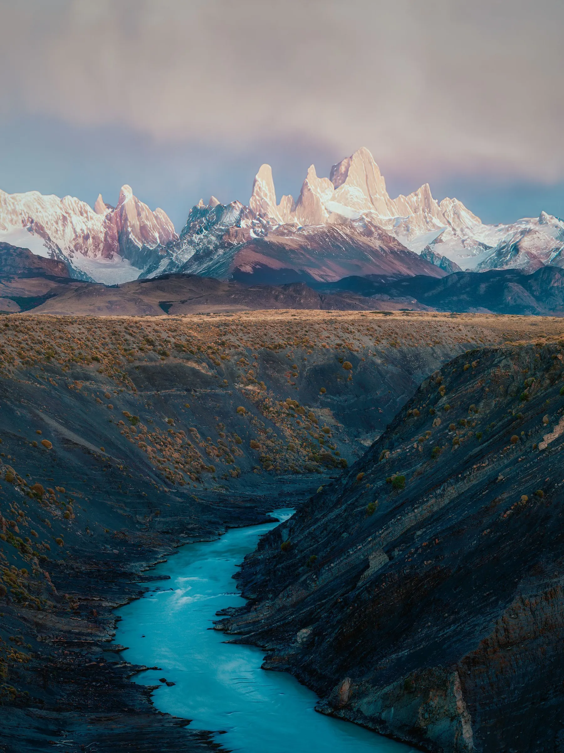 Blue river and rugged peaks in the Fitz Roy mountain landscape