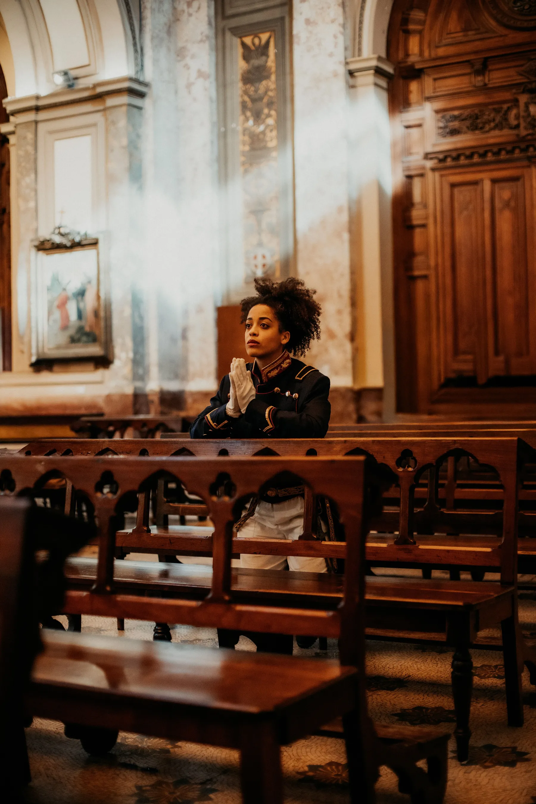 A quiet moment beneath the ornate interior of a Buenos Aires church.