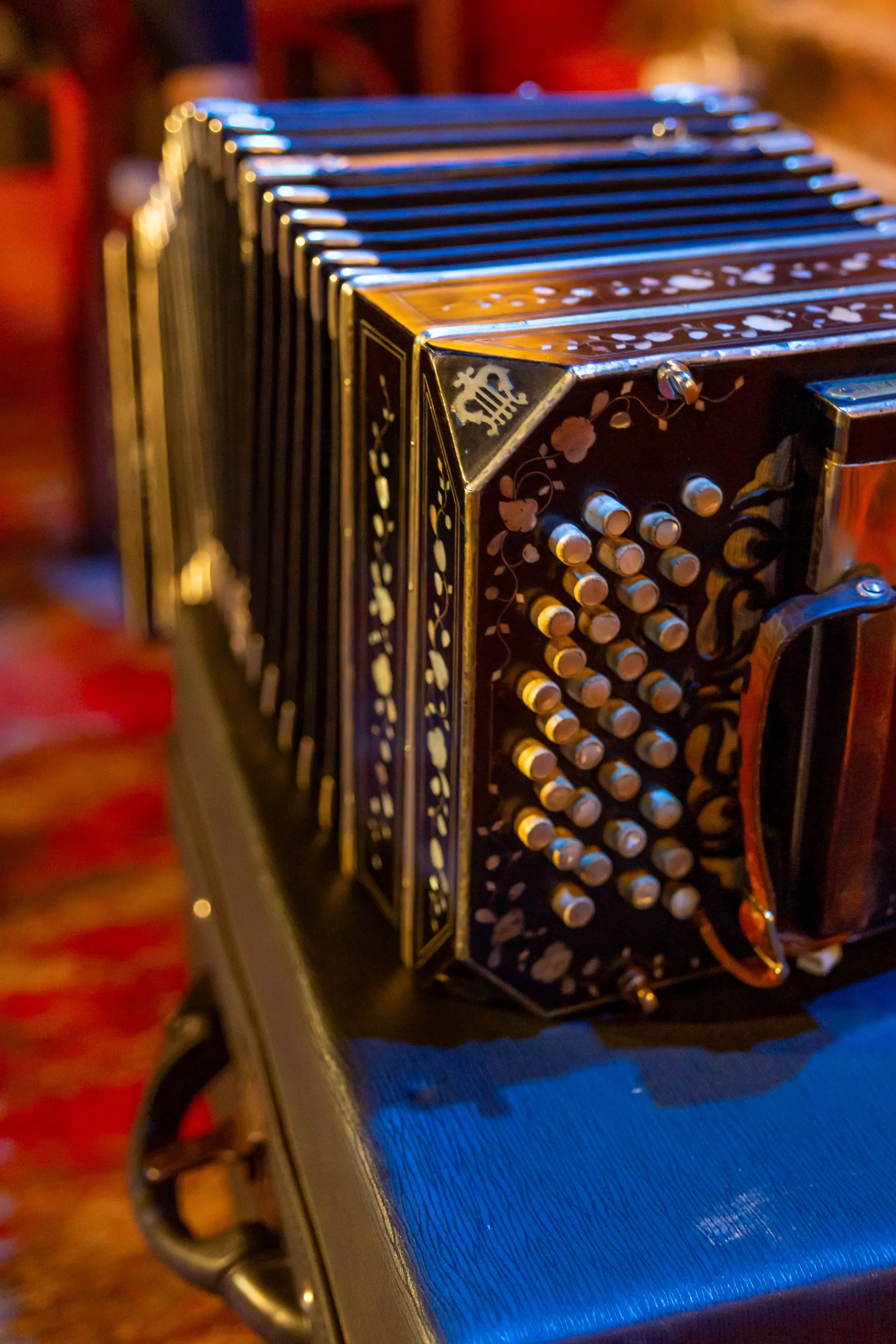 The ornate details of a bandoneón in warm light.