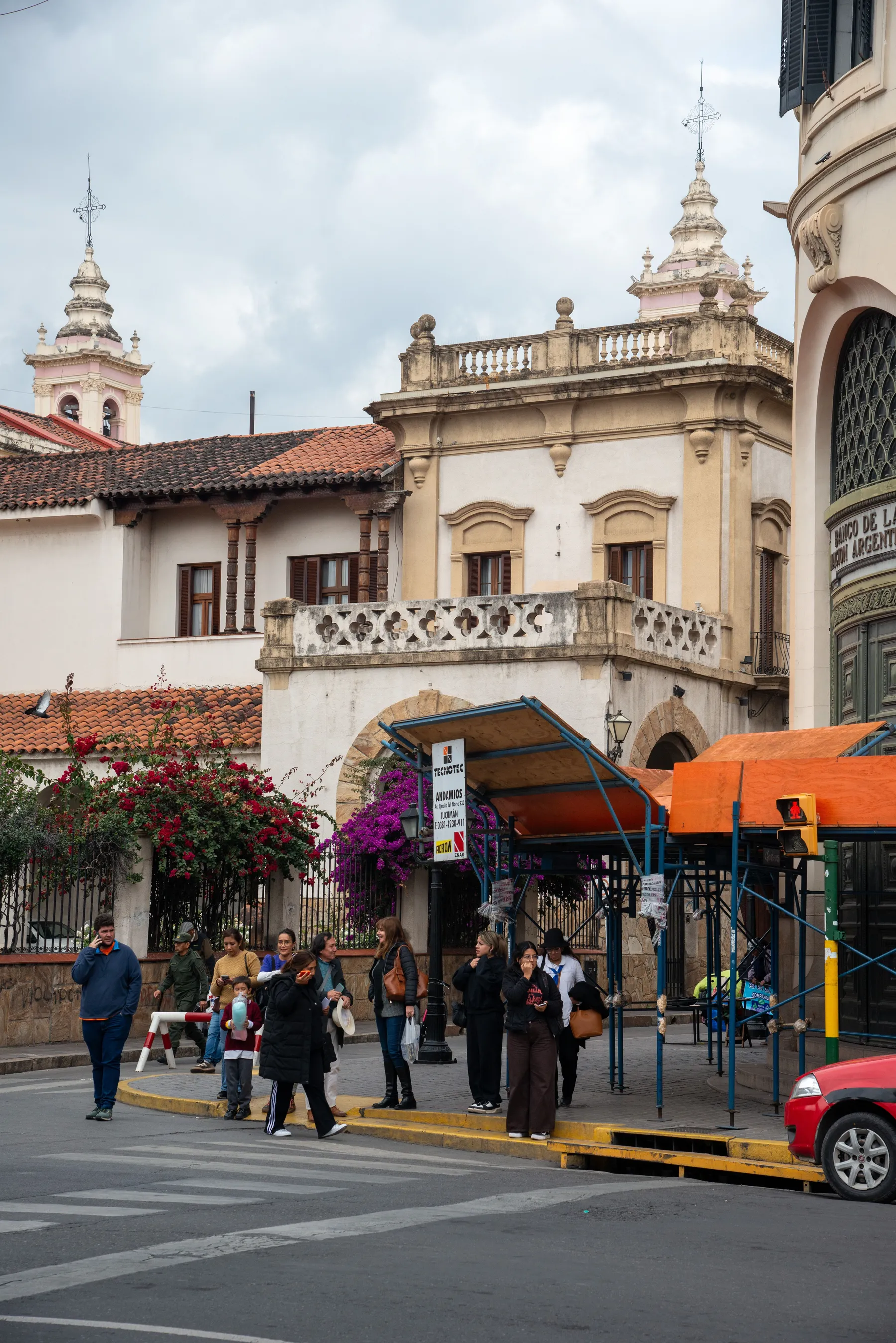 Daily street life among Salta's historic buildings.