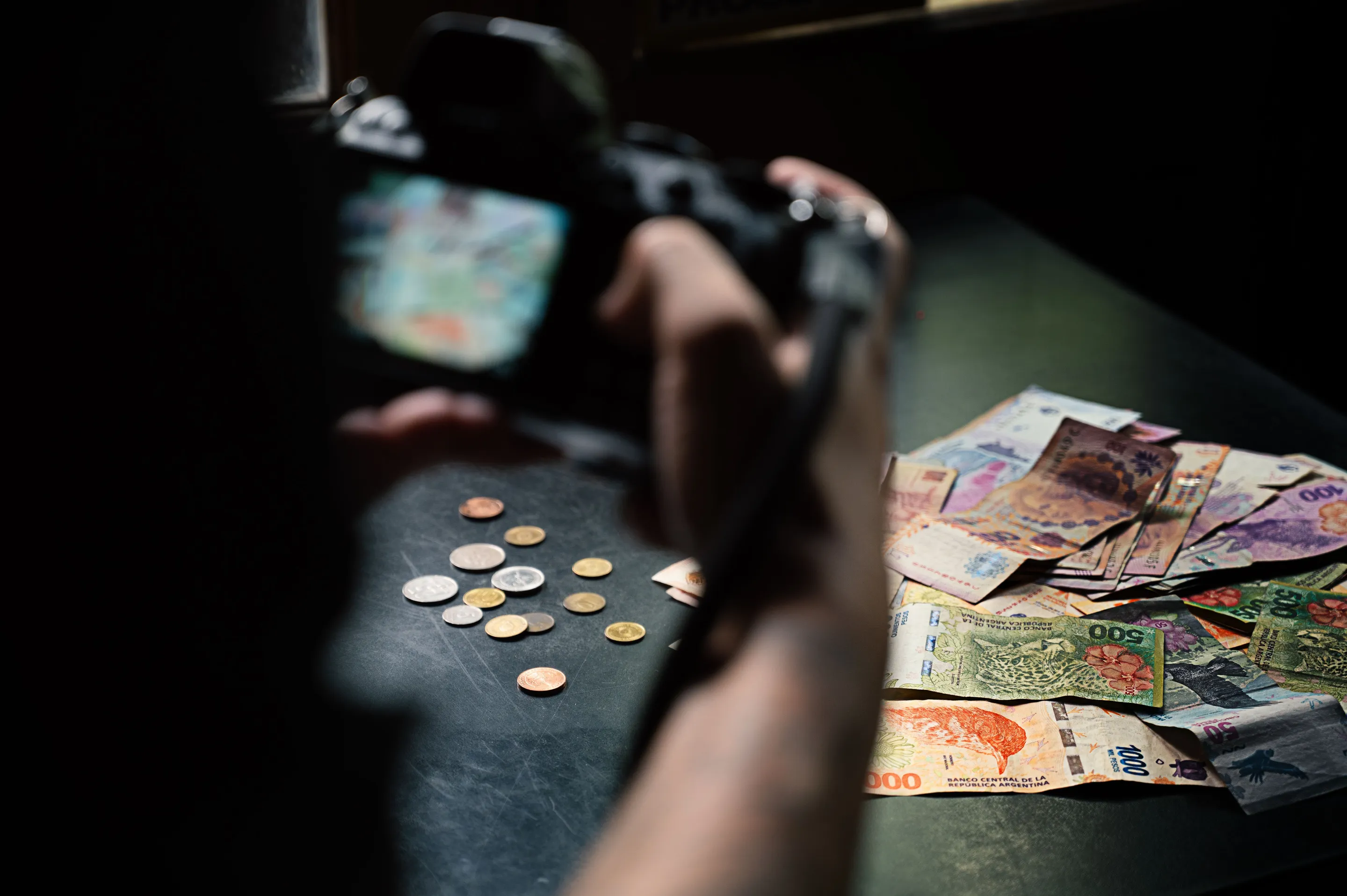 Argentine peso banknotes and coins shown in close detail.