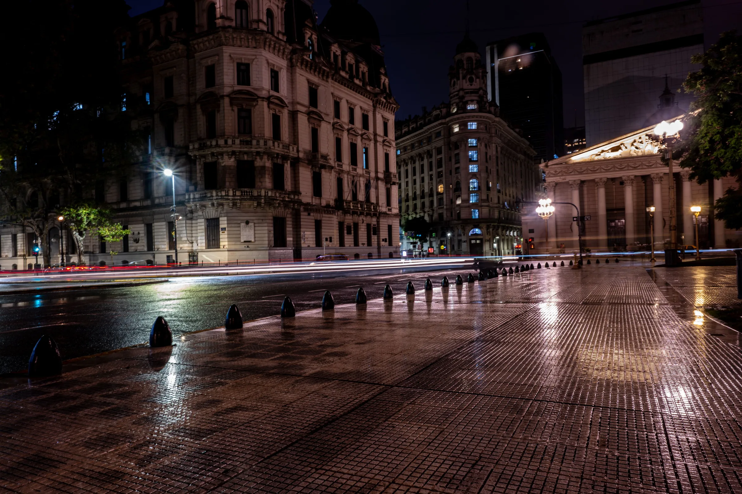 Rain catches the light along a historic Buenos Aires street.