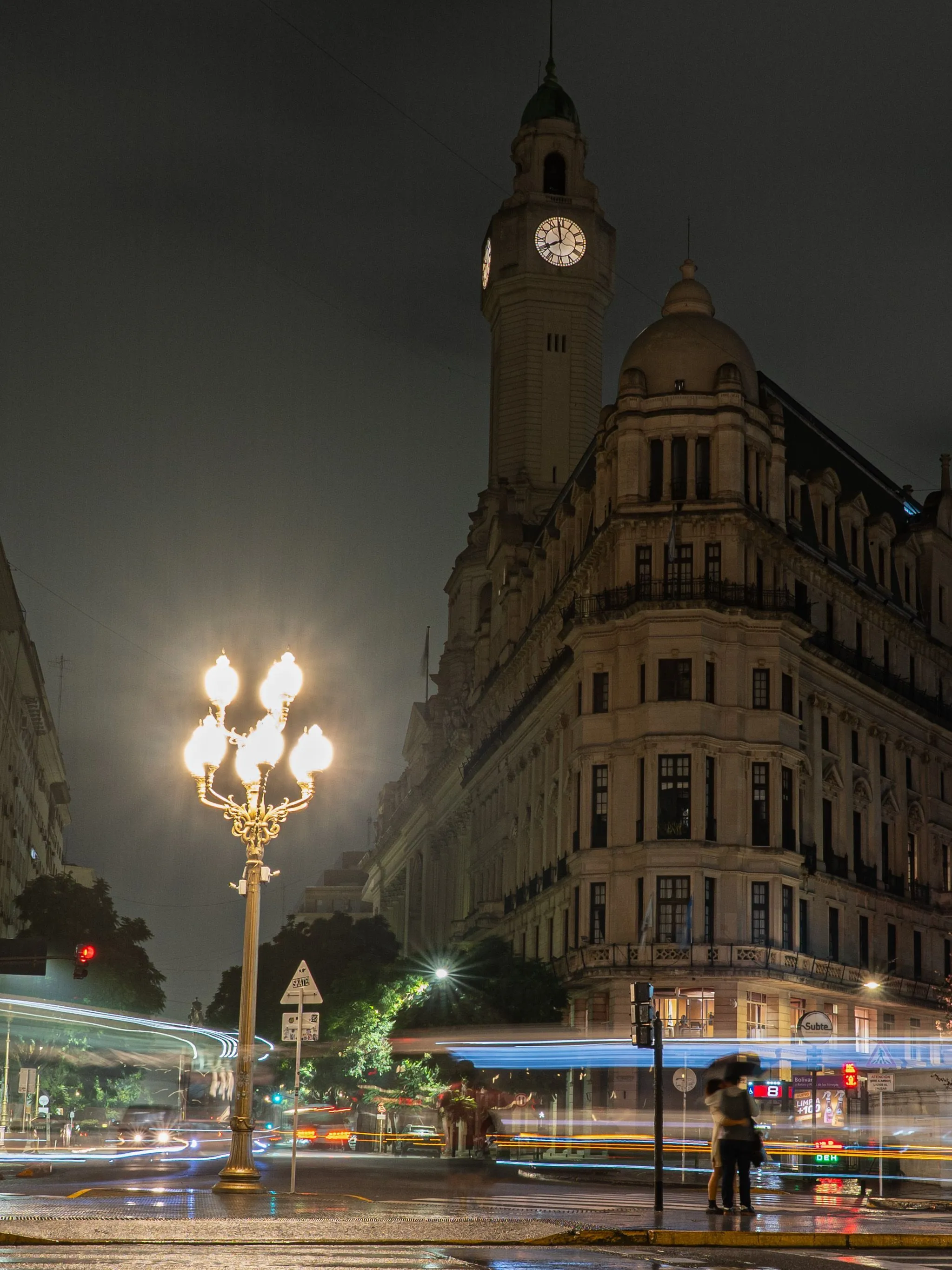 Illuminated historic architecture and streetlights in Buenos Aires at night