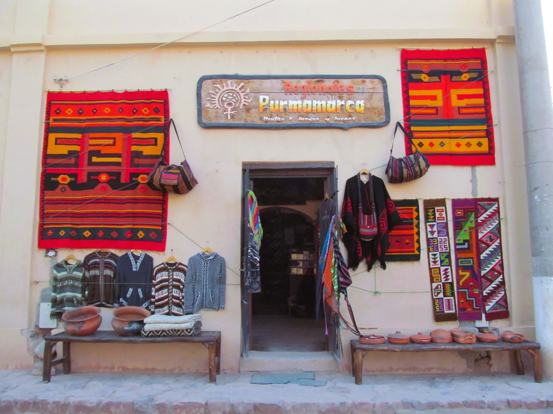 Colourful woven textiles displayed at an artisan shop in Purmamarca