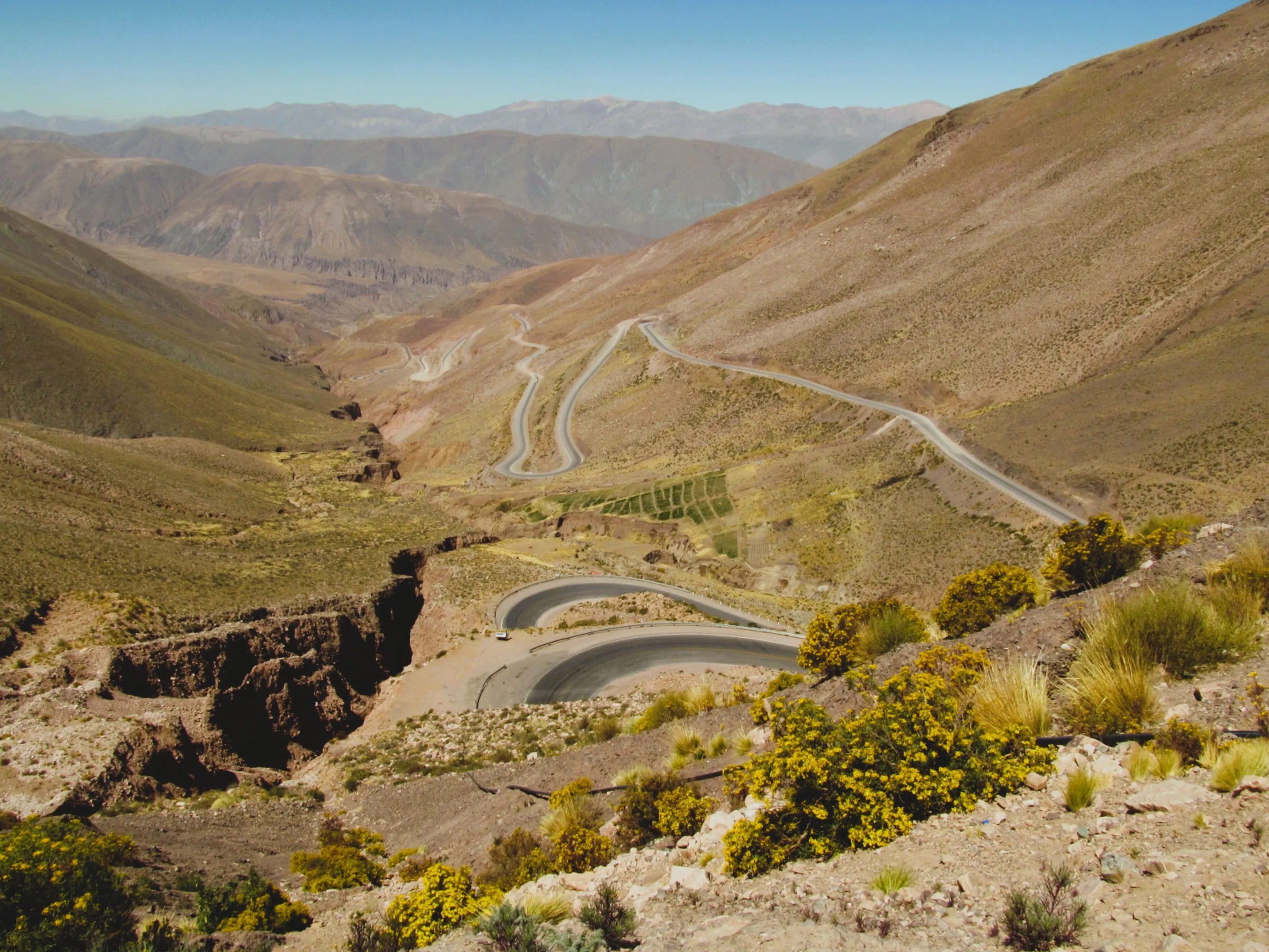 A winding road across open Andean slopes.