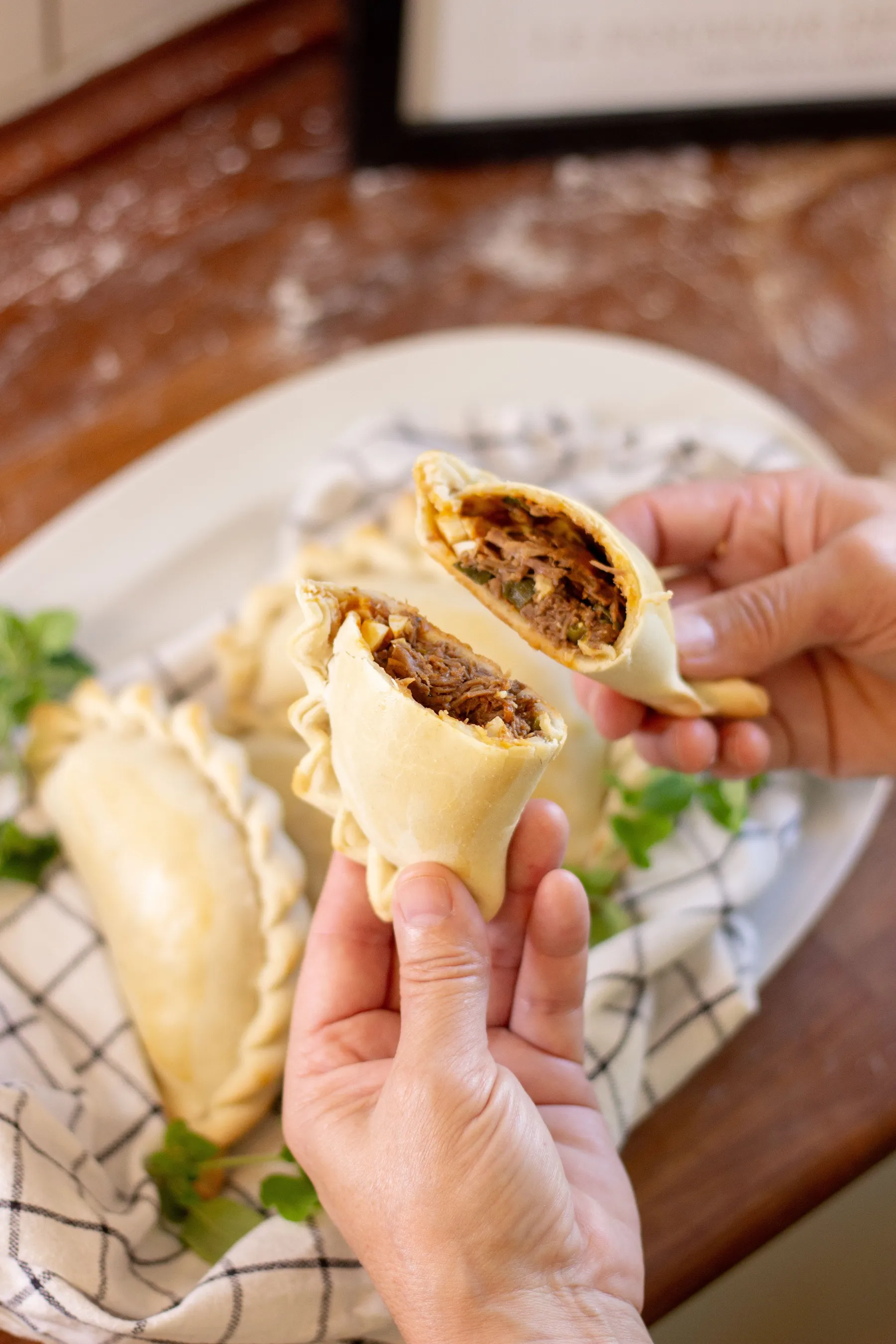 An empanada opened to reveal its savoury filling.