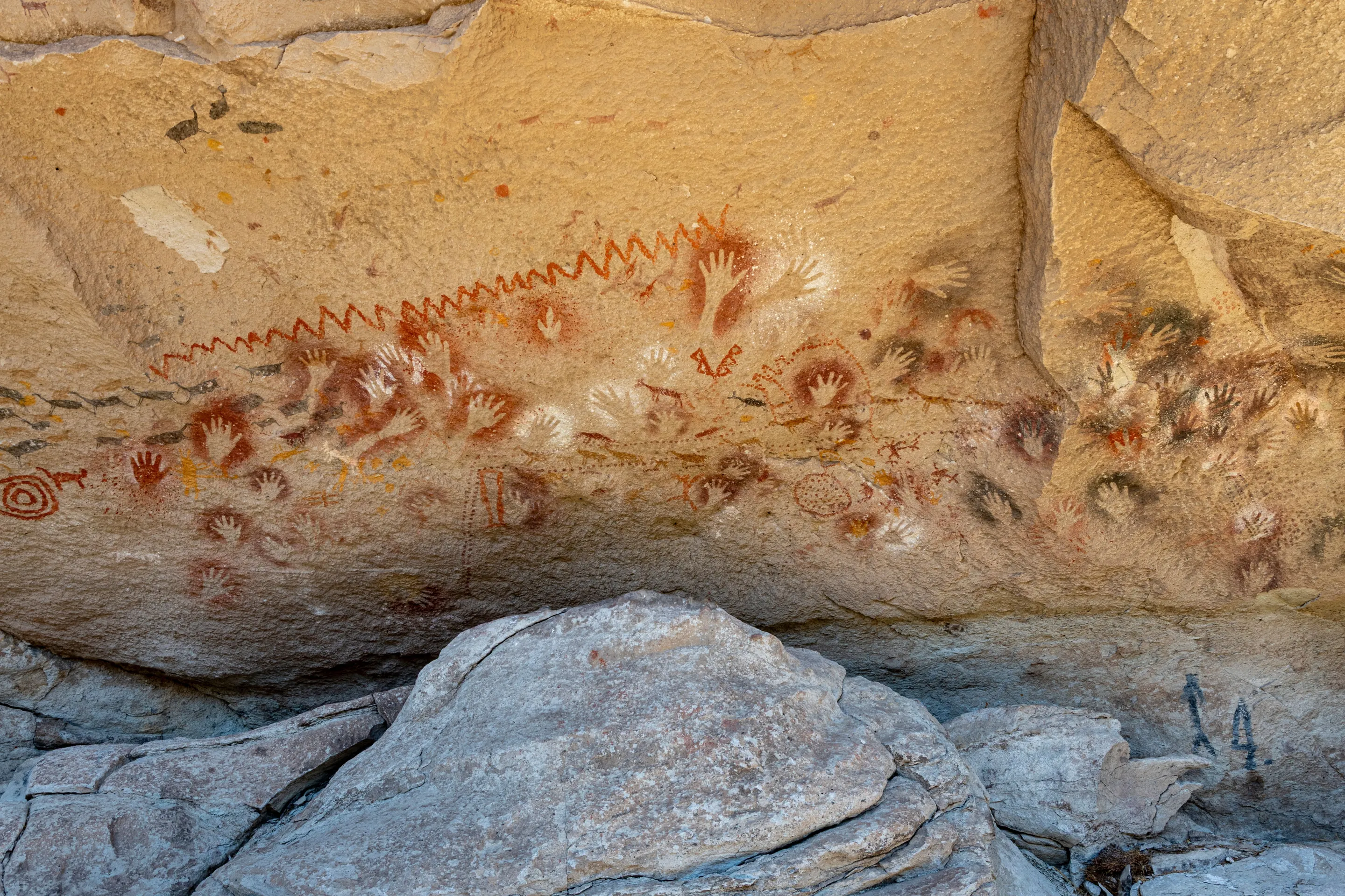 Overlapping hand stencils on textured rock