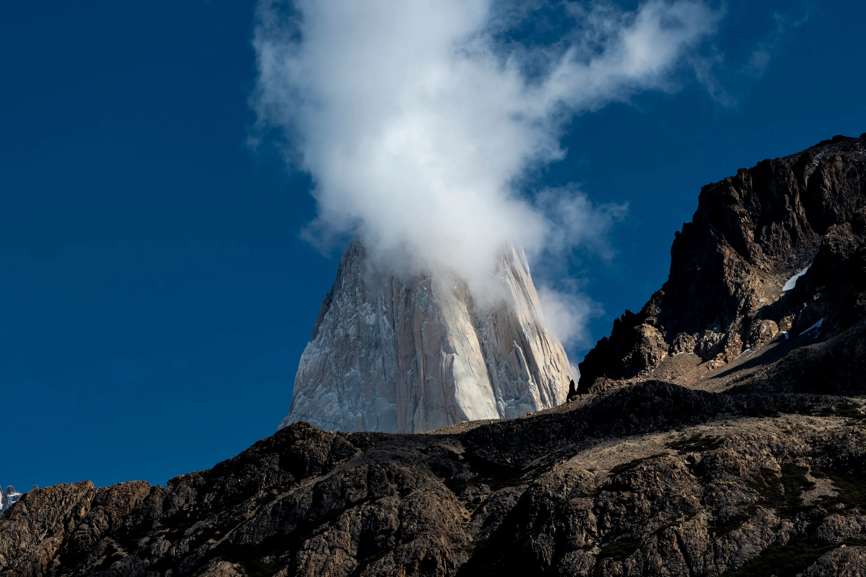 Cerro Torre near El Chaltén beneath cloud.