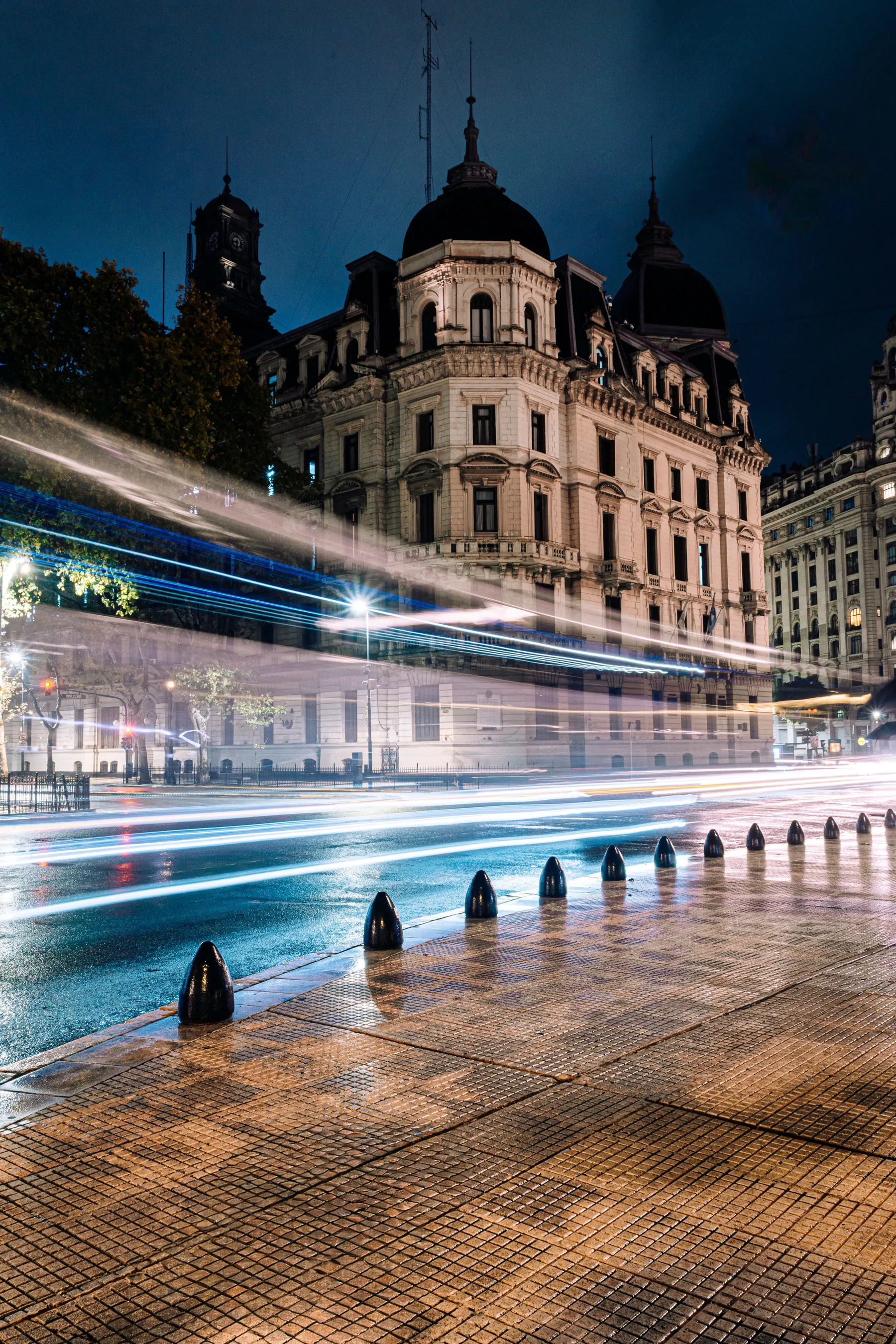 City light trails passing an illuminated historic building in Buenos Aires.