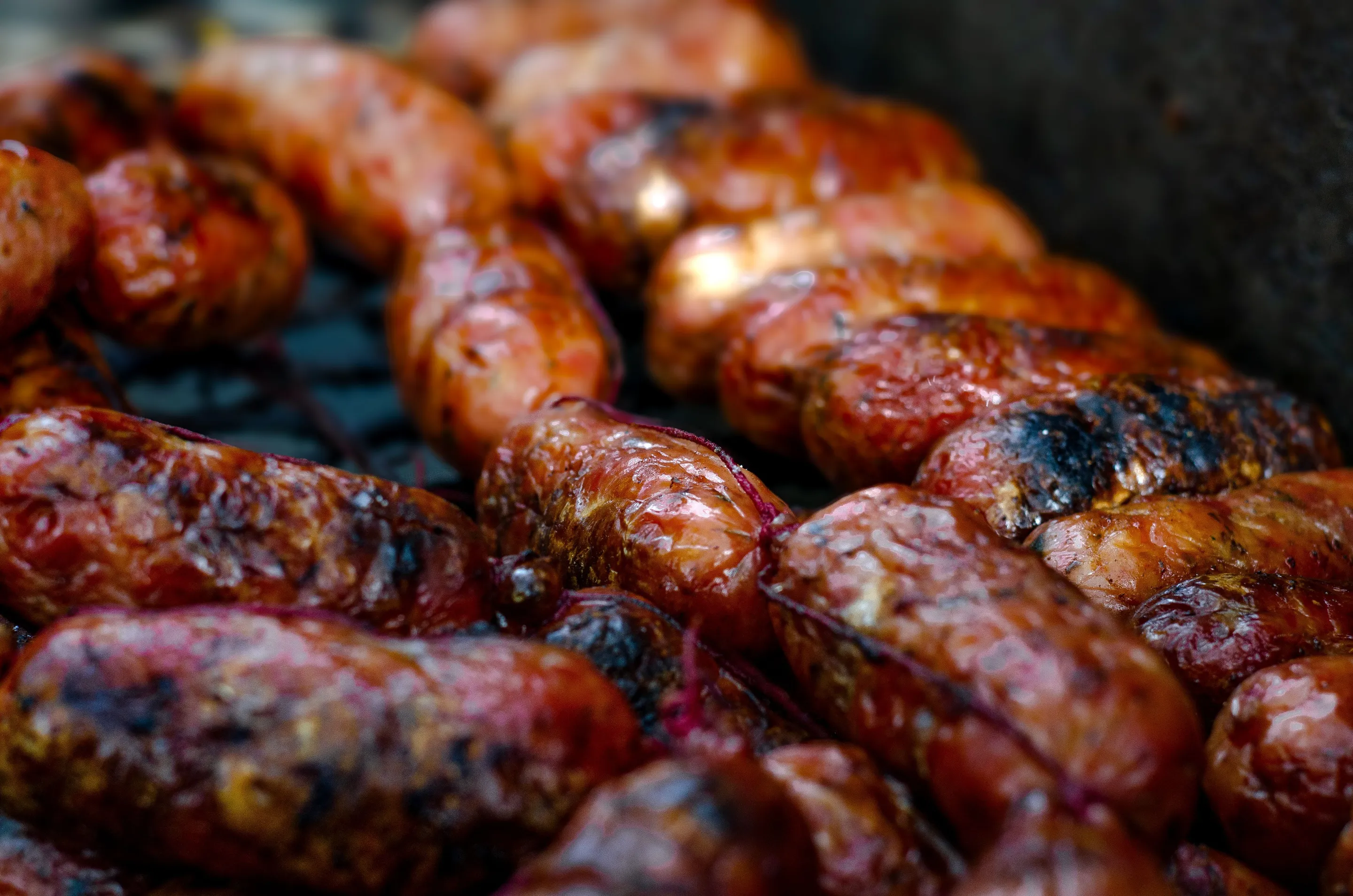 Chorizo cooking close over the grill in Buenos Aires.