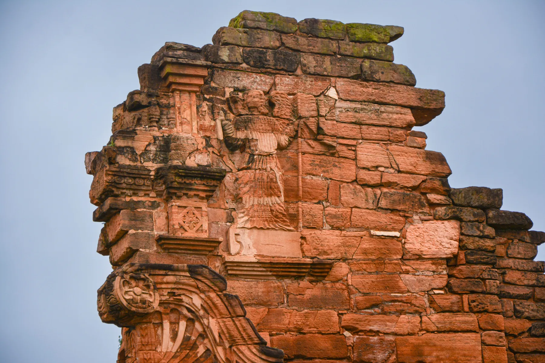 Red stone walls and carved details at San Ignacio Miní