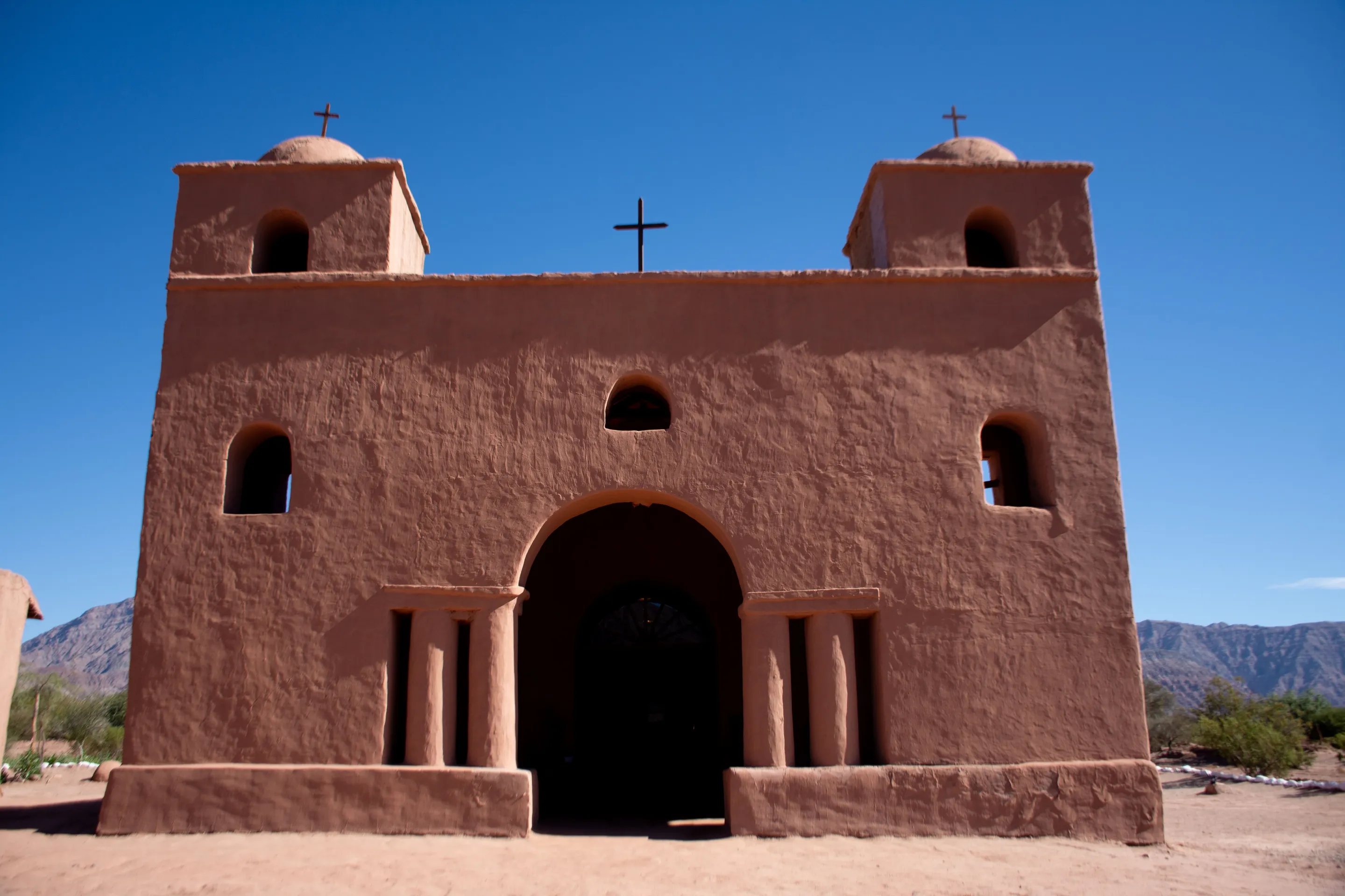 An adobe church beneath the clear sky in Cachi.
