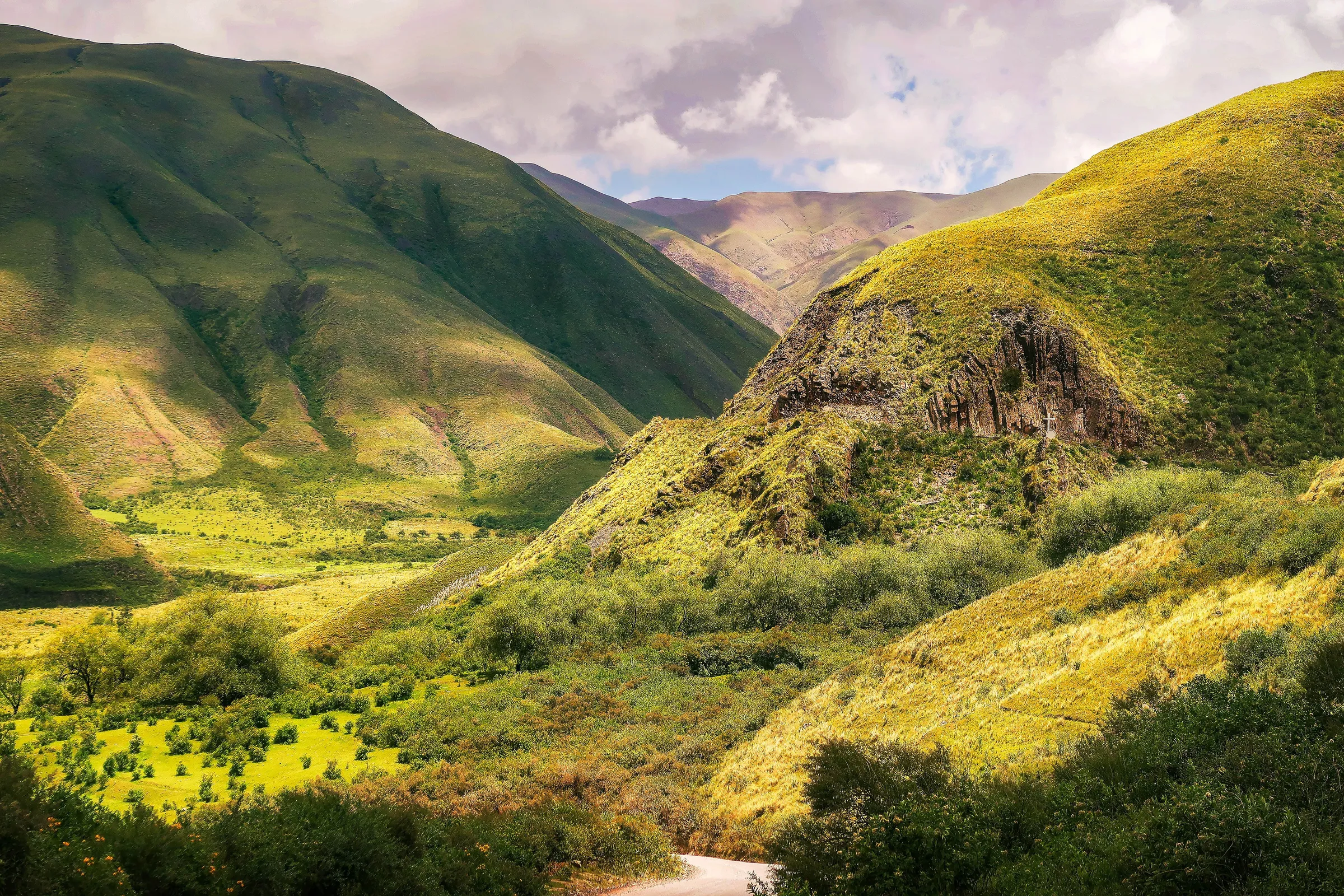 Green valleys and coloured mountain slopes in Salta Province.